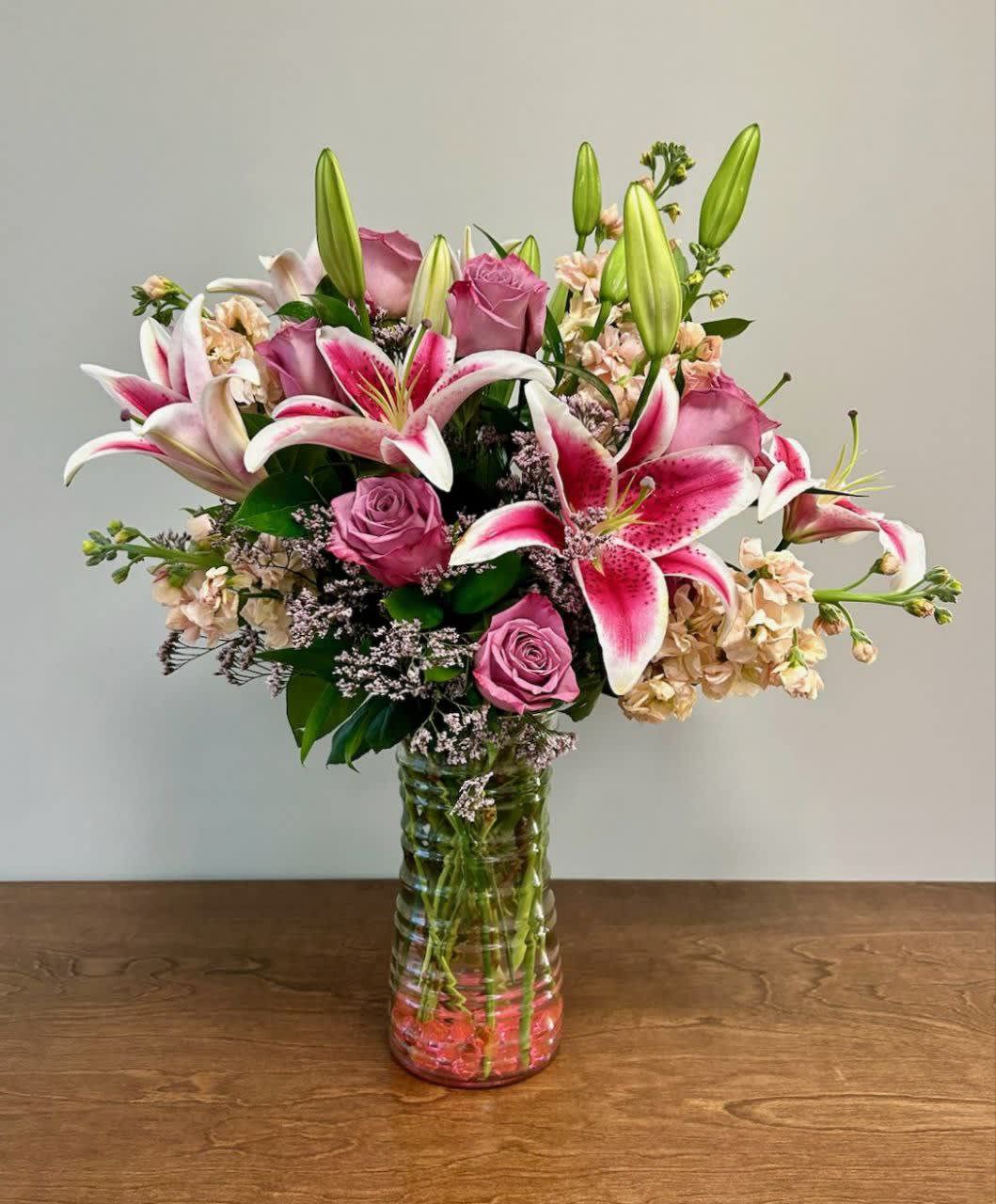 Lily Love Lily Love - Lilies are of unmatched beauty and elegance and so is this bouquet. This gorgeous combination of stargazer lilies accented with lavender roses is a dramatic display.