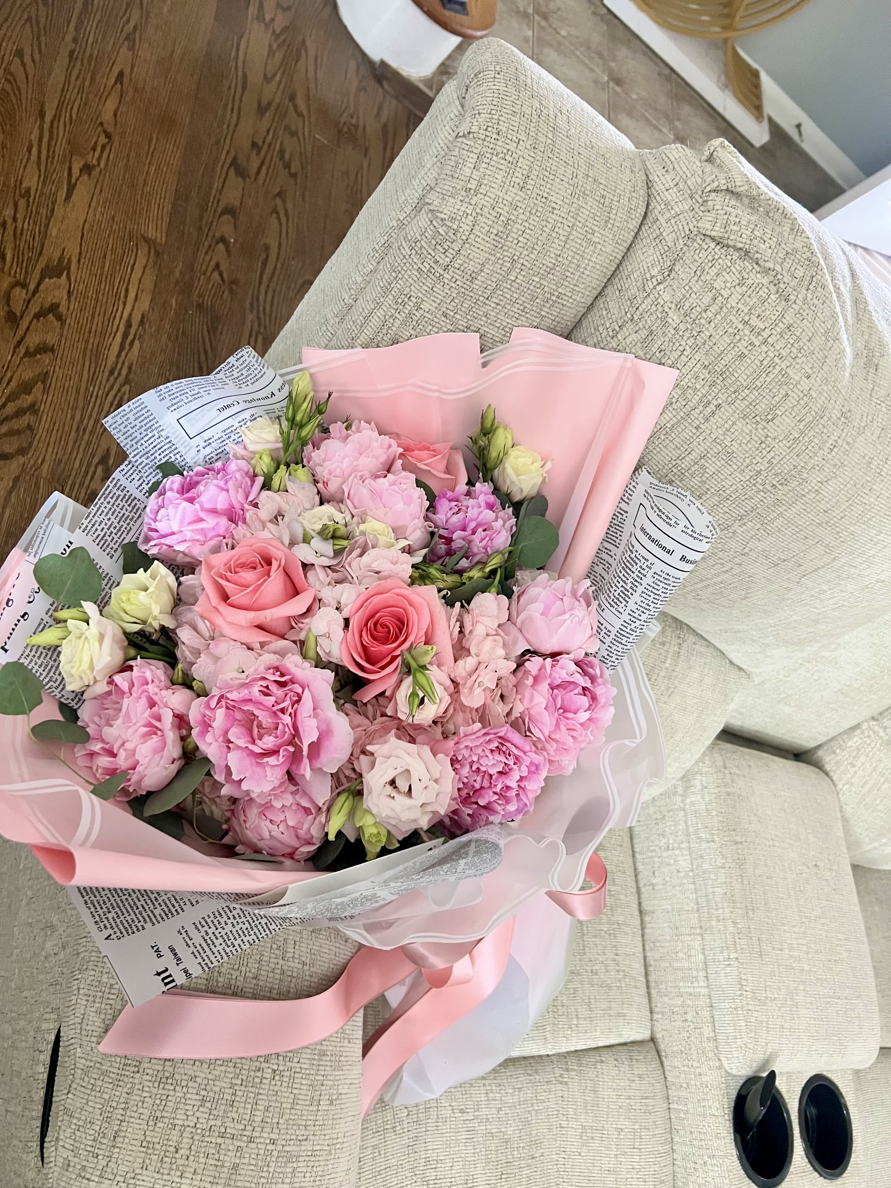 Peony Blossom - A dreamy blend of light pink peonies, creamy lisianthus, soft hydrangeas, and vibrant coral roses. Wrapped in sleek, modern paper, this bouquet is a graceful expression of sweetness and eleganc