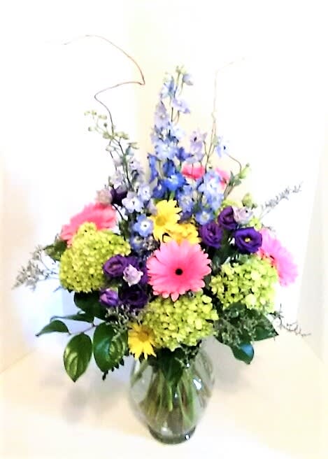 Flower Dance - A beautiful assortment of premium and long lasting flowers,including gerbera  daisies,hydrangeas,blue delphinium and more! 