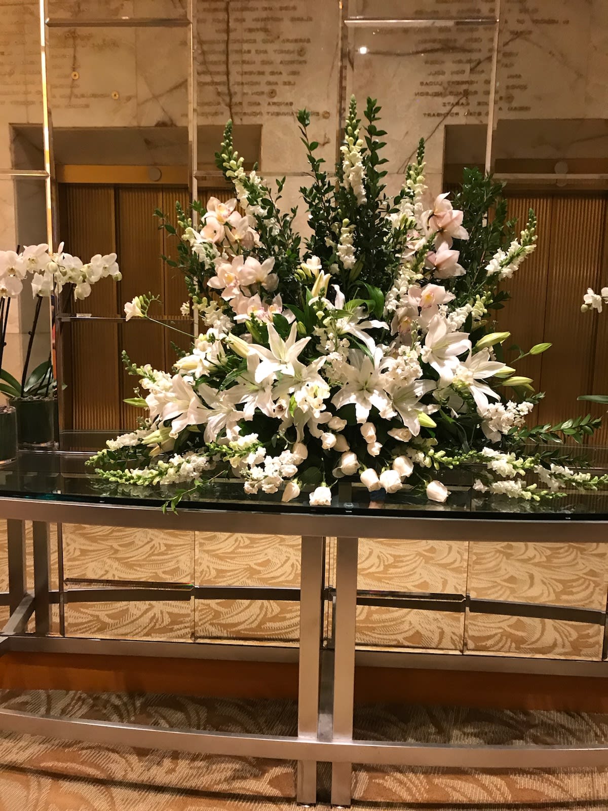 ELEGANT PLEASURES EVENT TABLE ARRAY ELEGANT PLEASURES EVENT TABLE ARRAY - A BEAUTIFUL DISPLAY OF ALL WHITE PREMIUM ORCHIDS, ROSES, SNAPS, LILIES, FRESIA AND MORE. 3 FEET TALL ,WITH A 2 FOOT WINGSPAN