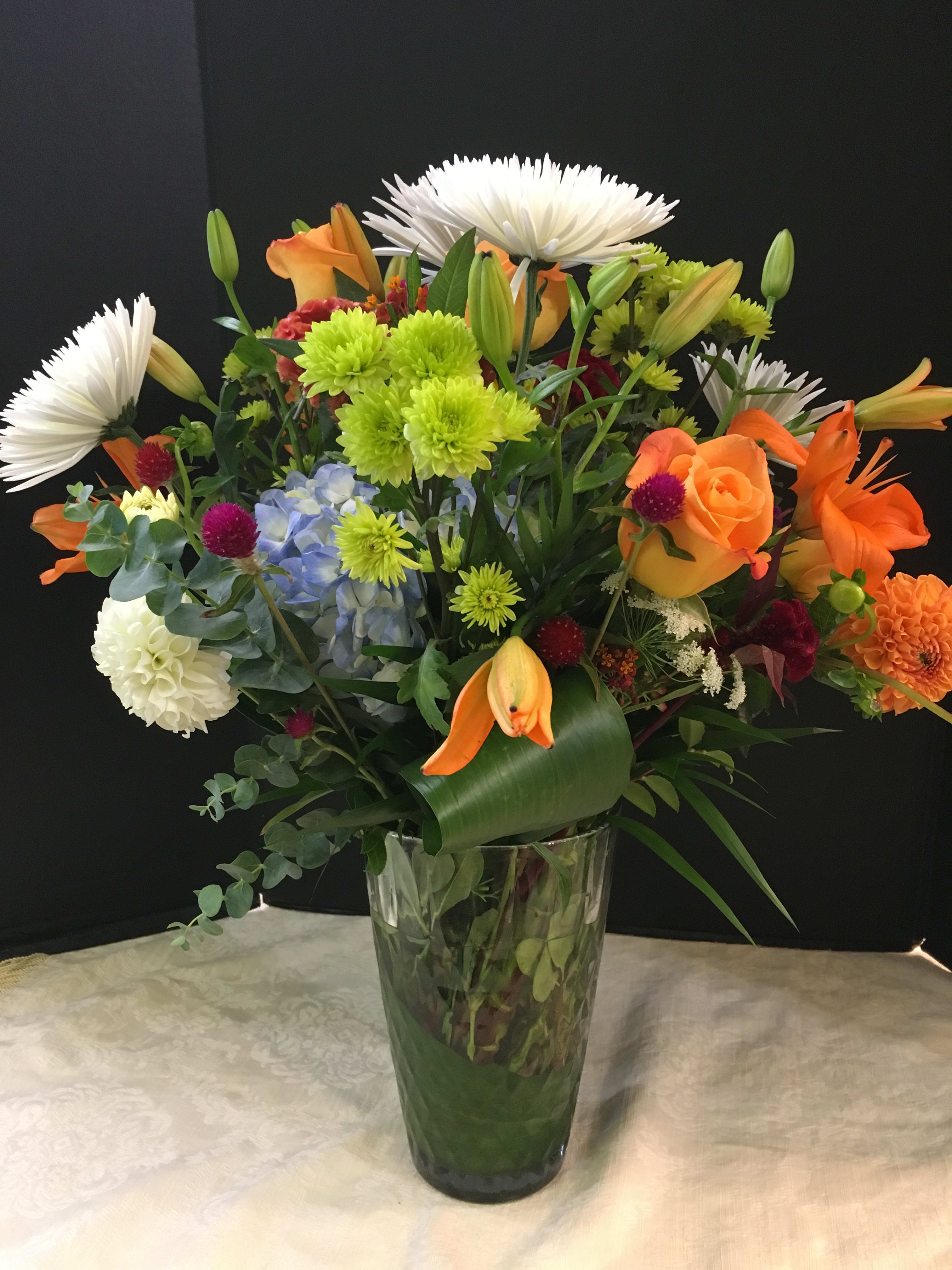 A Floral Delight for the Eye (Picture is Deluxe) -  Hydrangea, Asiatic Lilies, Roses, Spider Mums, Min. Sunflowers(Seasonal) , Green Button, Coxcomb and Assorted Greens