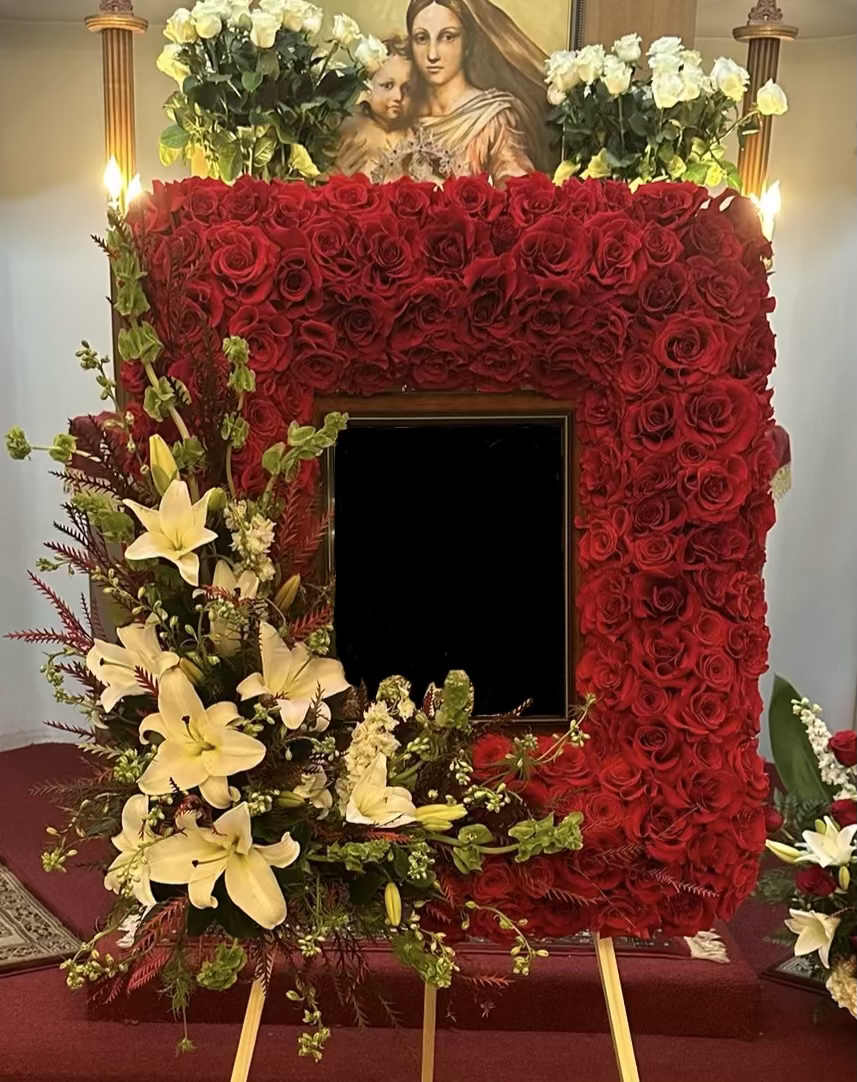 Lilies and Bells Frame By VLM Flowers Lilies and Bells Frame By VLM Flowers - This lovely frame comprises red Roses, white Lilies, and green Bells. In the corner, there is an accent of Lilies and Bells. It is exquisite and delicate frame.