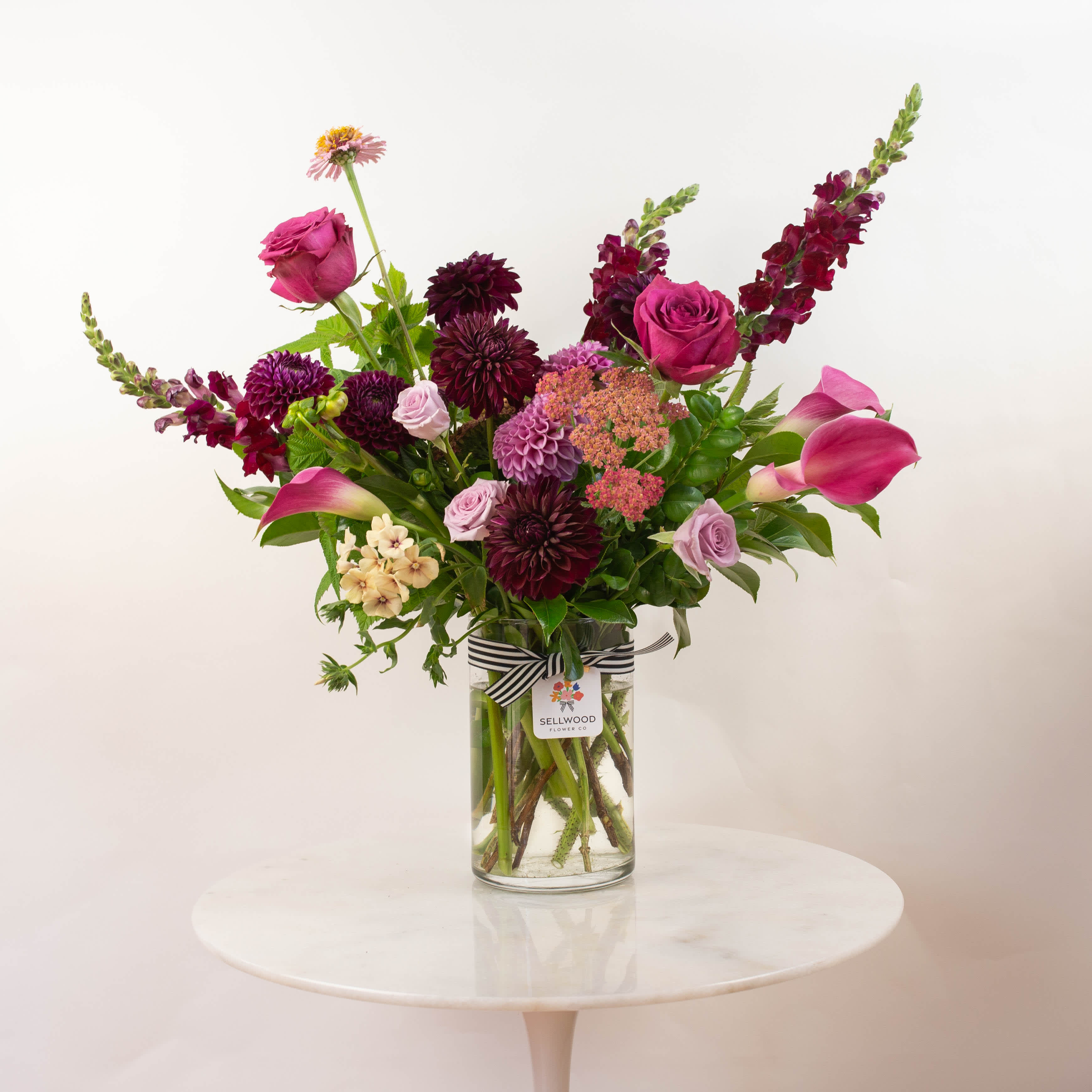 The Summer Sangria The Summer Sangria - A tall, bold, and beautiful arrangement featuring a seasonal collection of our freshest local flowers.