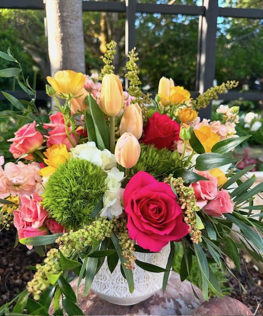 Summers Citrus Summers Citrus - fresh and bright colors perfect for any occasion. Hot pinks, orange, peach, greens, and yellows make up this summer favorite featuring roses, tulips, dianthus, hydrangeas, and ranunculus in a white ceramic container.