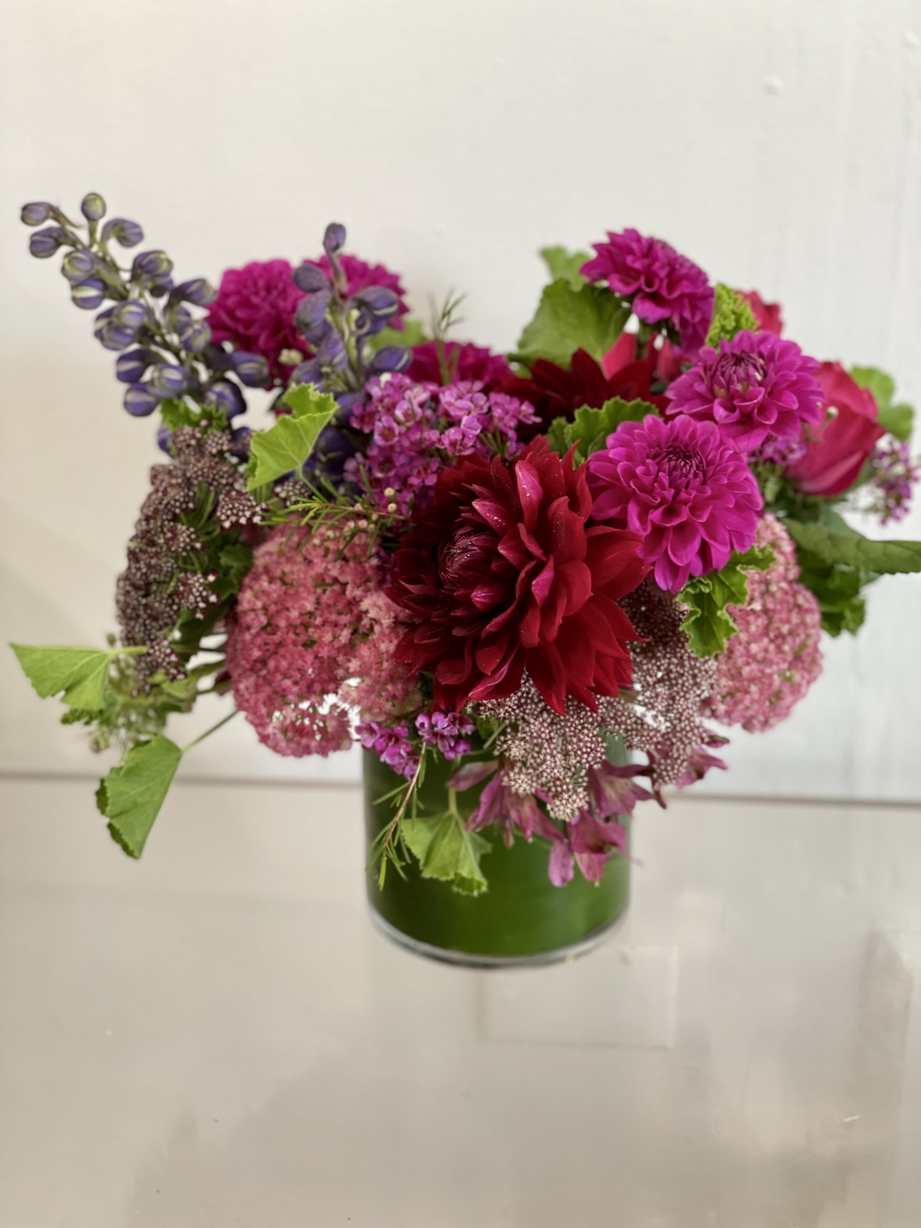 Jewel Toned Summer  - A  fresh bouquet of jewel toned flowers. Designers choice in a ti leaf lined vase. Perfect for a side table or coffee table.   If any design element such as color or flower/foliage are very important to your order please contact us to ensure availability first by calling the shop at  415 751 2747 or info @ fleurtstyle com