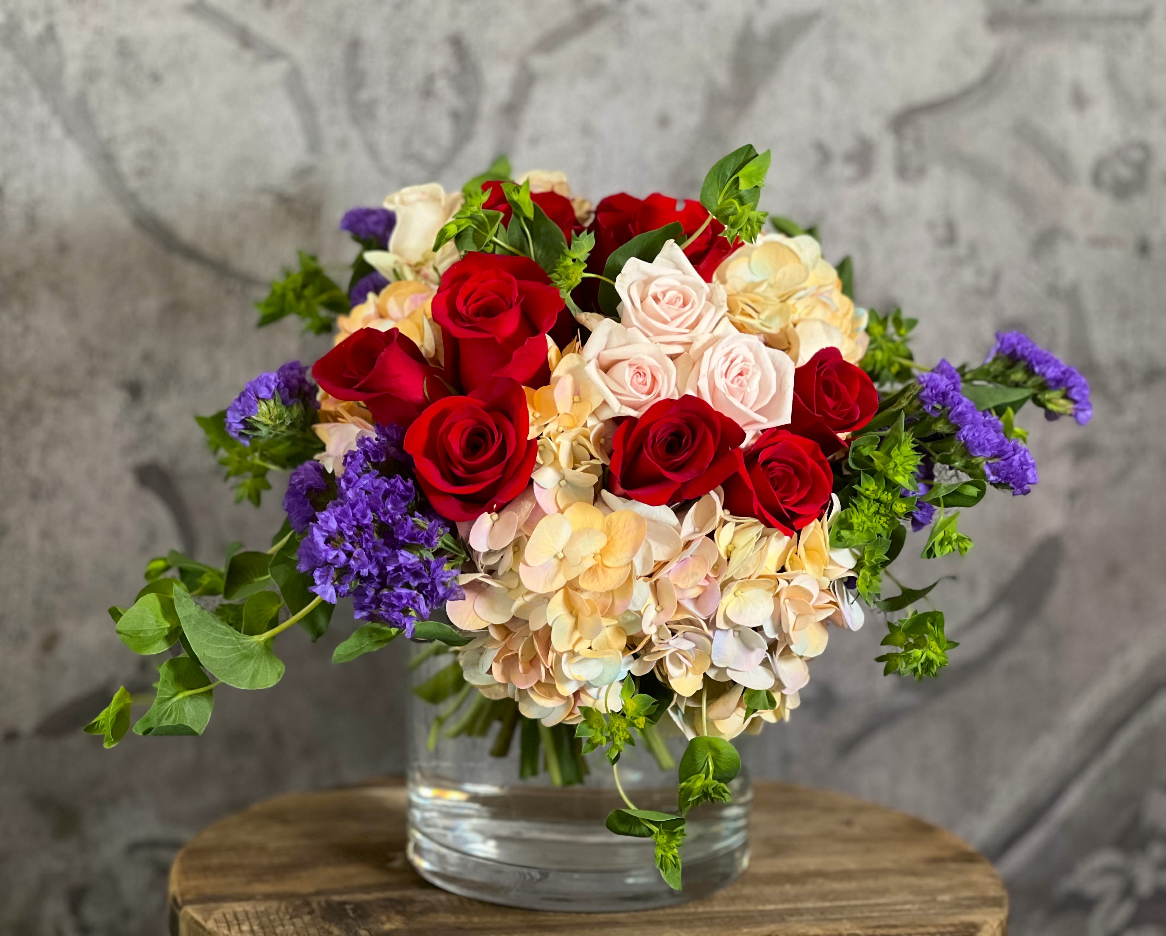 Summer Romance Summer Romance - This beautiful arrangement of Roses, Hydrangea, and Statice reminds us of a Summer Romance!