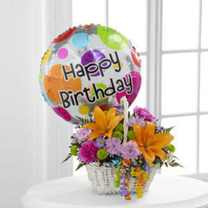 The FTD® Happy Blooms™ Basket - The FTD® Happy Blooms™ Basket brings together Asiatic lilies and carnations to create the perfect way to send your happy birthday wishes! Orange Asiatic lilies, lavender chrysanthemums, lavender carnations, purple monte casino asters, green button poms and lush greens are beautifully arranged within a rectangular whitewash willow handled basket accented with colorful curling ribbon. Arriving with a bright Mylar balloon exclaiming, &quot;Happy Birthday,&quot; this flower arrangement will add to the celebration of their special day. 