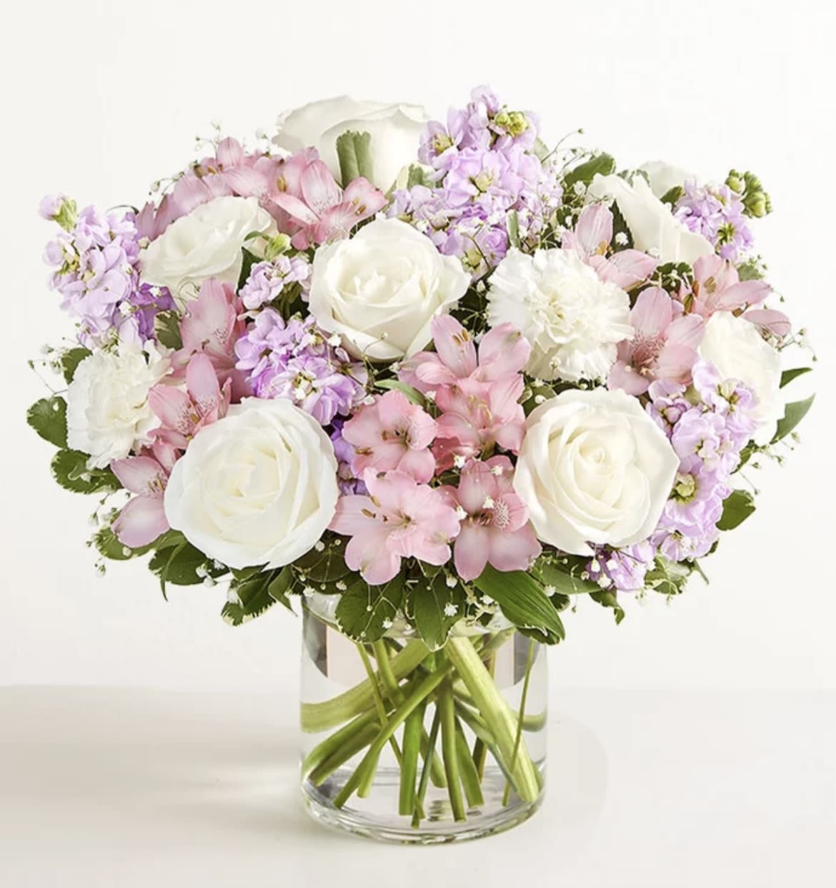 Oh baby ! Oh baby ! - roses , stock , carnations , alstromeria , in shades of pinks and whites in a glass cylnder or cube