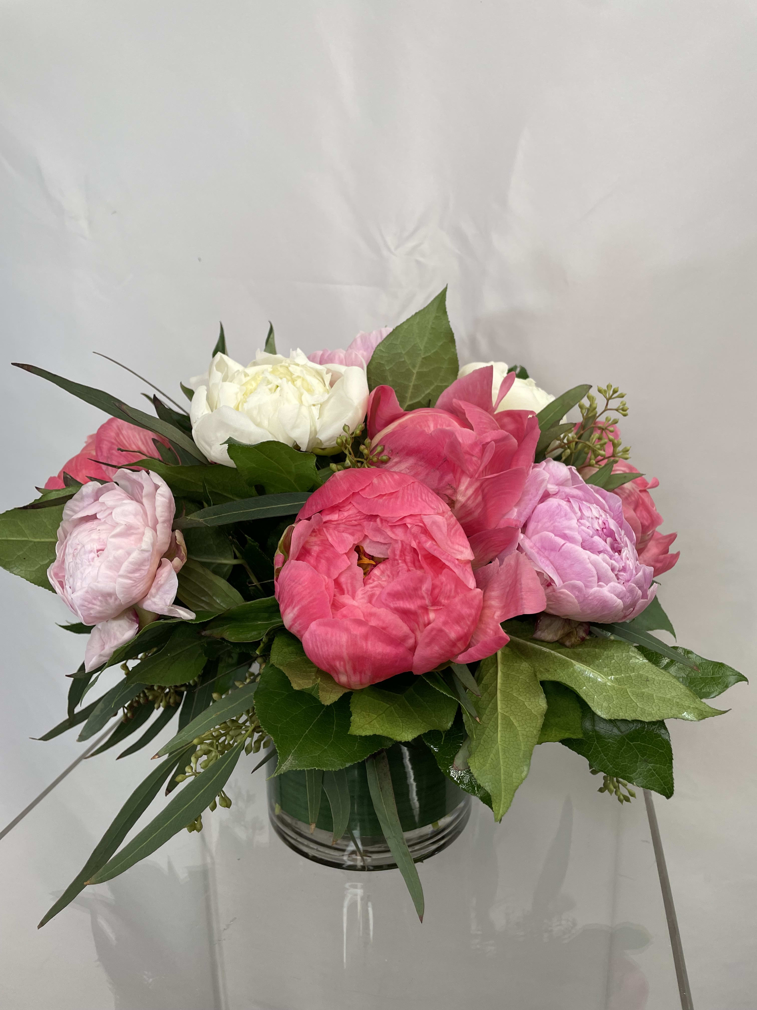 Pretty Peonies  - Peonies are such a beautiful flower!! Stunningly arranged in a glass cylinder with complimenting greens. It is simple, sweet and elegant! 