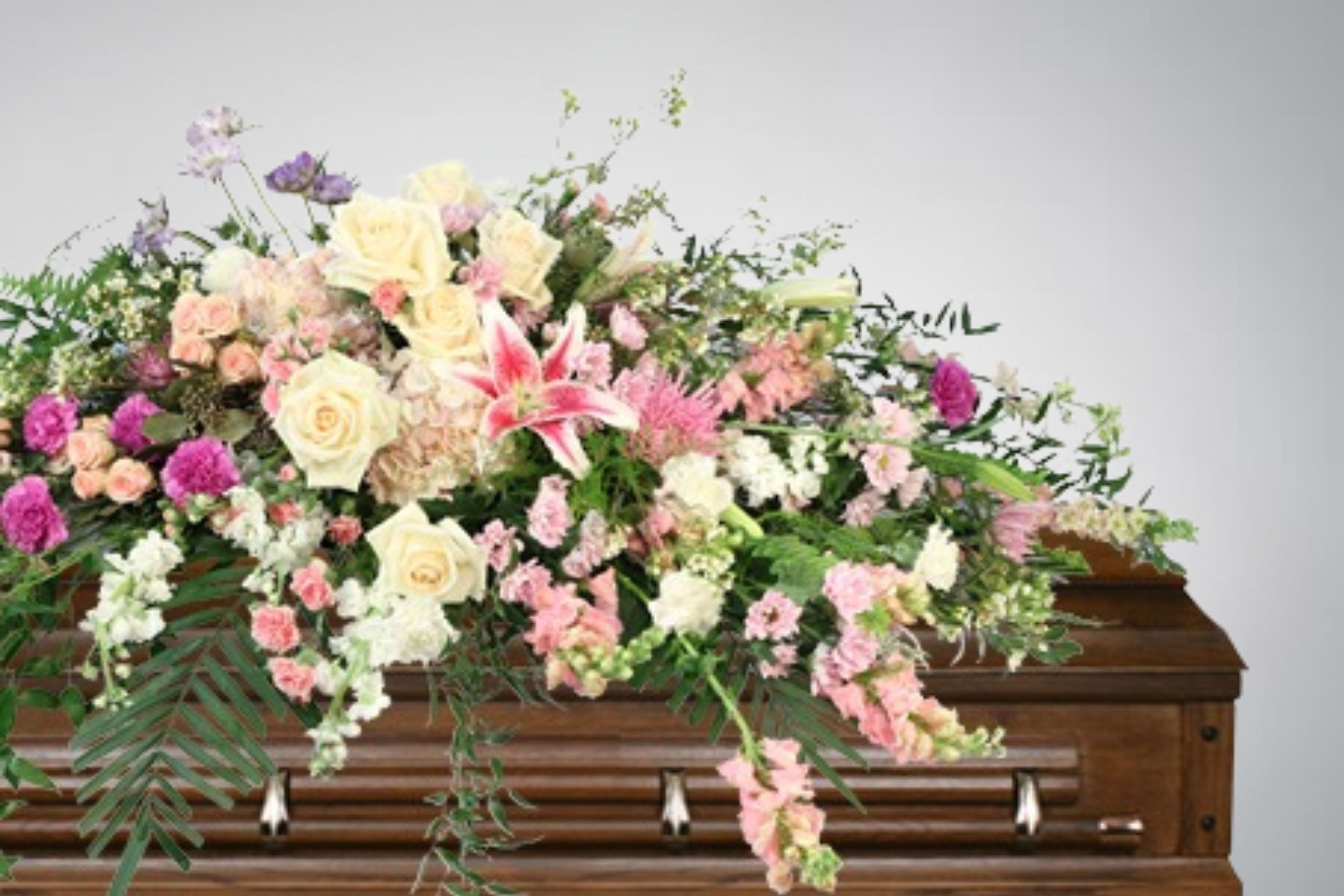Cascading calm casket spray - Elegantly cascading in hues of pink and white, Cascading Calm is a tender tribute to a loved one. With a harmonious blend of hydrangeas, roses, snapdragons, stargazer lilies, and daisy poms, each blossom whispers a story of love and remembrance. The delicate petals offer comfort in the midst of sorrow.  Includes: Casket Saddle W, Seeded Eucalyptus, Emerald Palm, Plumosus, Italian Ruscus, Salal, Flat Fern, Dried Mushrooms, White Carnations, Pink Mini Carnations, Light Purple Moon Carnations, Pink Hydrangeas, Pink Larkspur , Stargazer Lily, Lavender Daisy Poms, White Roses, Blue Scabiosa, Pink Snapdragons, Lavender Spider Mum, Blush Spray Roses, White Stock, White Waxflower. Copyrighted content provided by &lt;a href=&quot;http://www.flowershopnetwork.com&quot;&gt;FlowerShopNetwork.com&lt;/a&gt;.