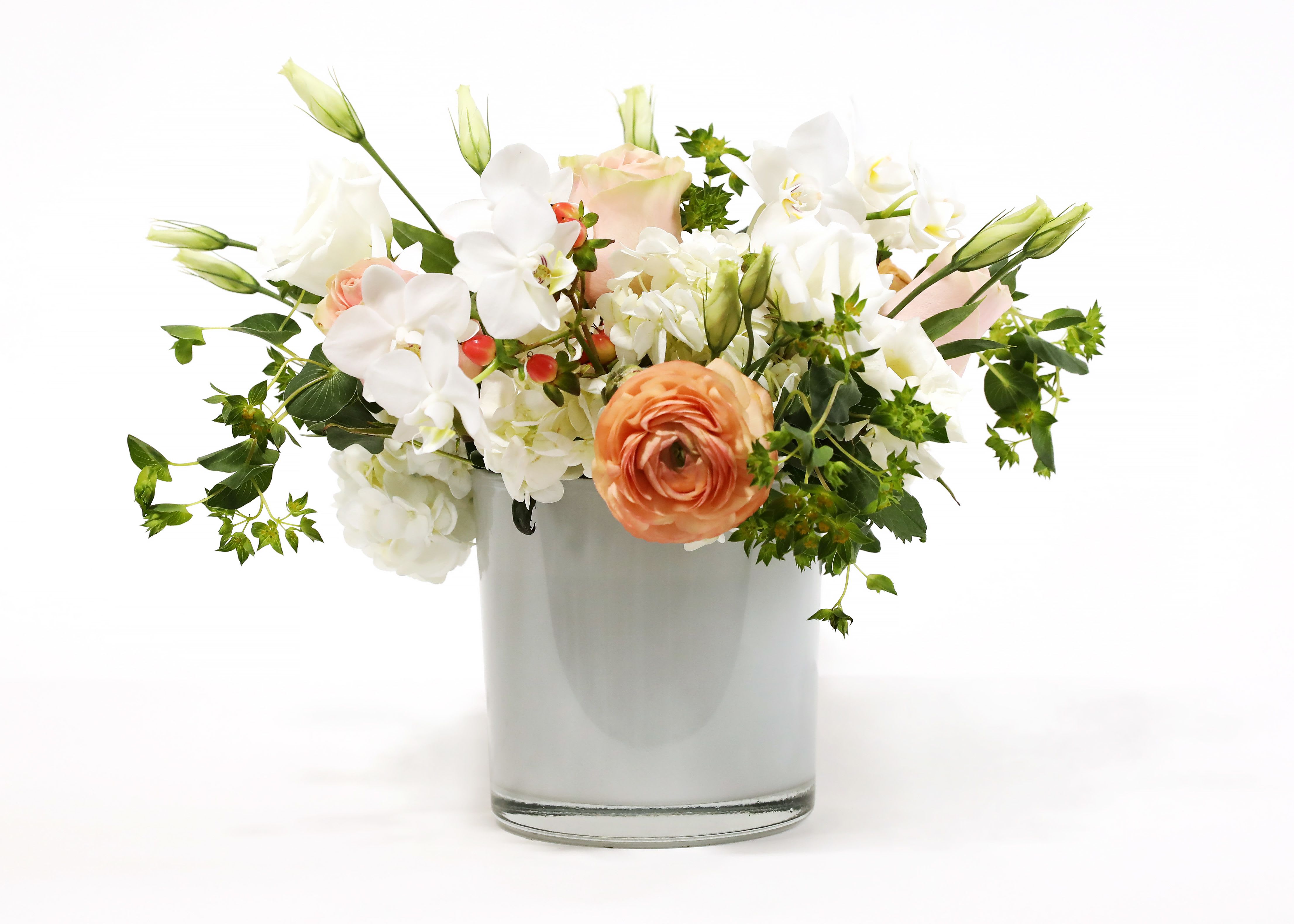 SIMPLY SERENE SIMPLY SERENE - THIS BEAUTIFUL WHITE CYLINDER VASE HAS WHITE AND PINKS, WHICH INCLUDE HYDRANGEA, ROSES, ORCHIDS, AND RANUNCULUS.