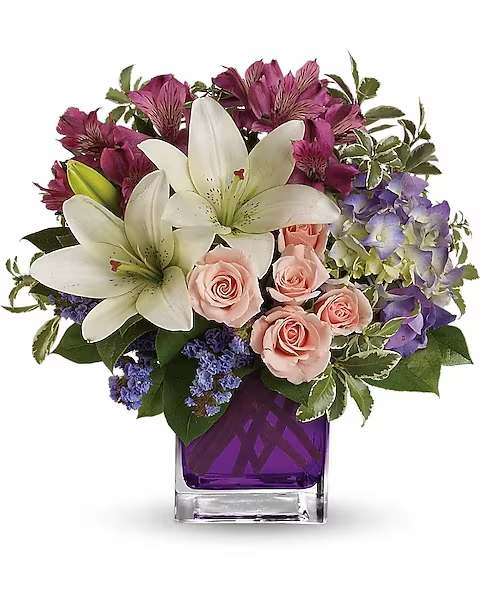 Teleflora's Garden Romance - Hello, gorgeous! This bouquet includes purple hydrangea, light pink spray roses and white asiatic lilies and arranged in our vibrant violet glass cube.  Purple hydrangea, light pink spray roses, white asiatic lilies, dark pink alstroemeria and lavender sinuata statice are accented with assorted greens. Delivered in Teleflora's glass violet cube.