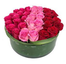 Amor Amor - (01) Beautiful tight elegant colored roses in pave design. (low glass vase) Your choice of color roses! Substitutions may be necessary due to availability.