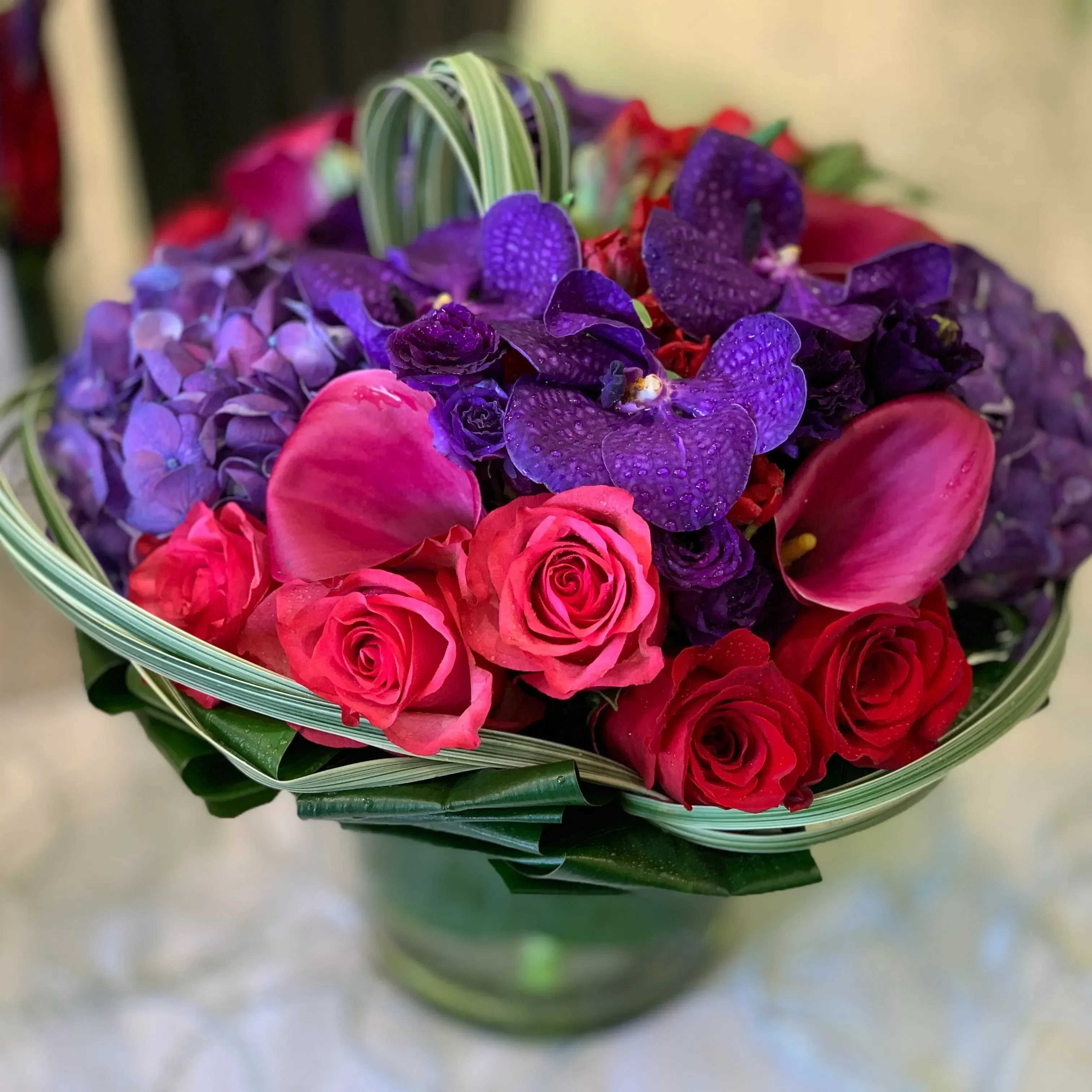 Berry Bliss Berry Bliss - (83) A captivating floral arrangement that weaves together a harmonious tapestry of pinks, purples, and reds, creating a visual symphony of color. This exquisite ensemble features a variety of blooms in varying shades, each carefully selected to evoke a sense of lushness and delight.