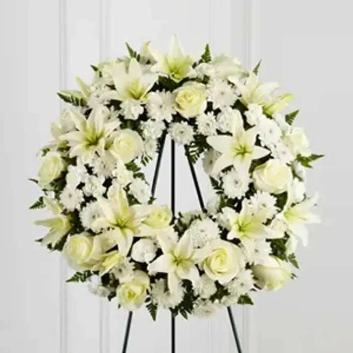 Treasured Tribute Wreath - White wreath with roses, lilies, carnations and cushions