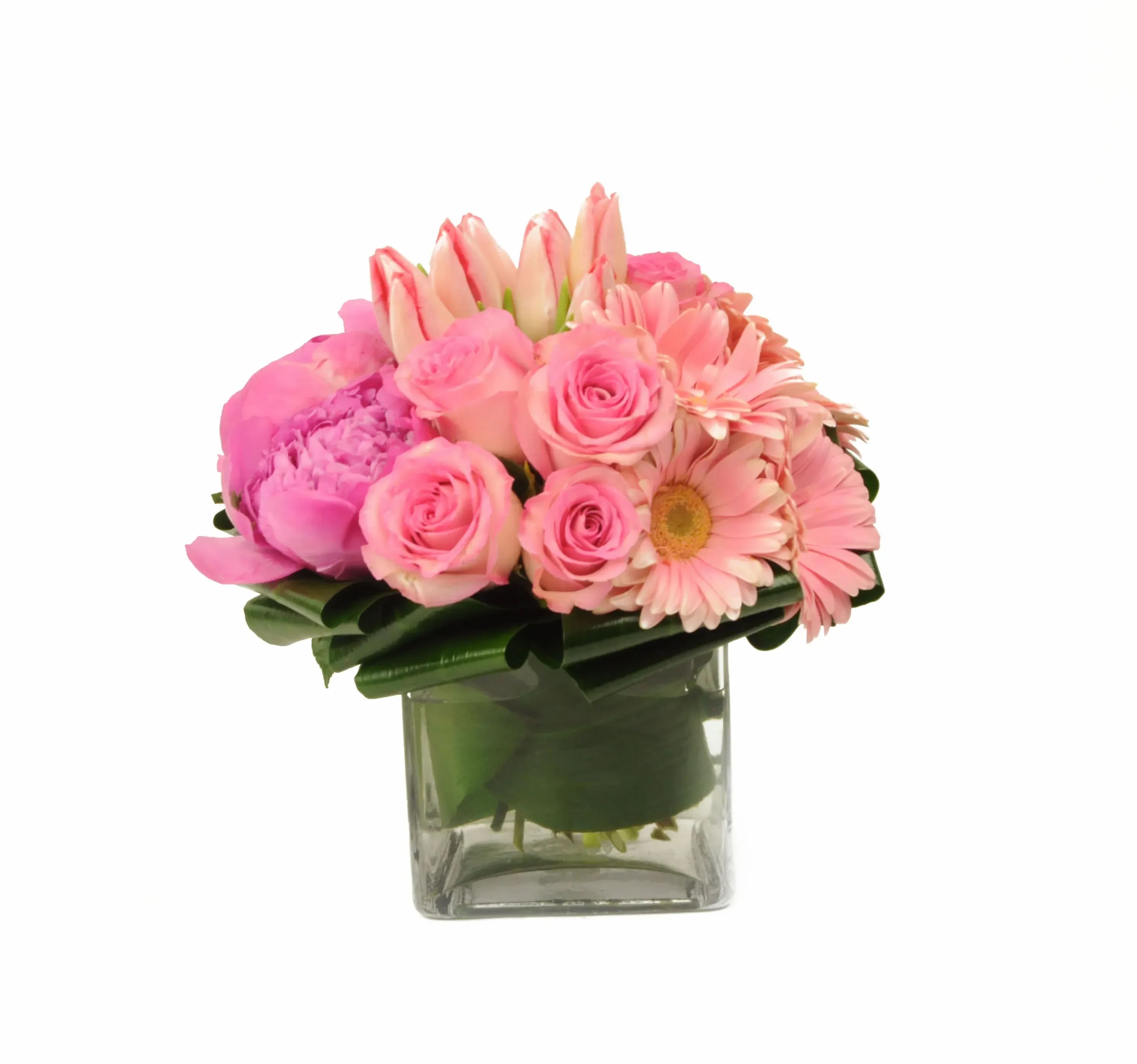 Pink &amp; Proper - (39) Pink &amp; Proper is a pink lover's dream come true! The finest light and medium tone pink garden flowers joined together in a low lush style clear leaf wrapped glass. Substitutions may be necessary due to availability.