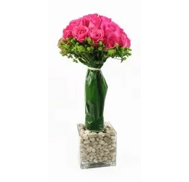 Rock My World Rock My World - (73) One of our favorite arrangements that is sure to make a statement and catch the gaze of anyone who sets their sights on it! Intricately arranged pink roses (available in the color of your choice) in topiary design with a halo of green berries. Stems are wrapped in premium green leaves and placed in clear square glass filled with river rocks. Substitutions may be necessary due to availability.