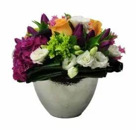 Summer Love  - (59) A graceful balance of deep color tones blended with vibrant whites and yellows. Brighten someone's day with this refreshing medley of hydrangeas, lisianthus, tulips, roses, and hyacinths- paired perfectly with an oval silver vase. Substitutions may be necessary due to availability.