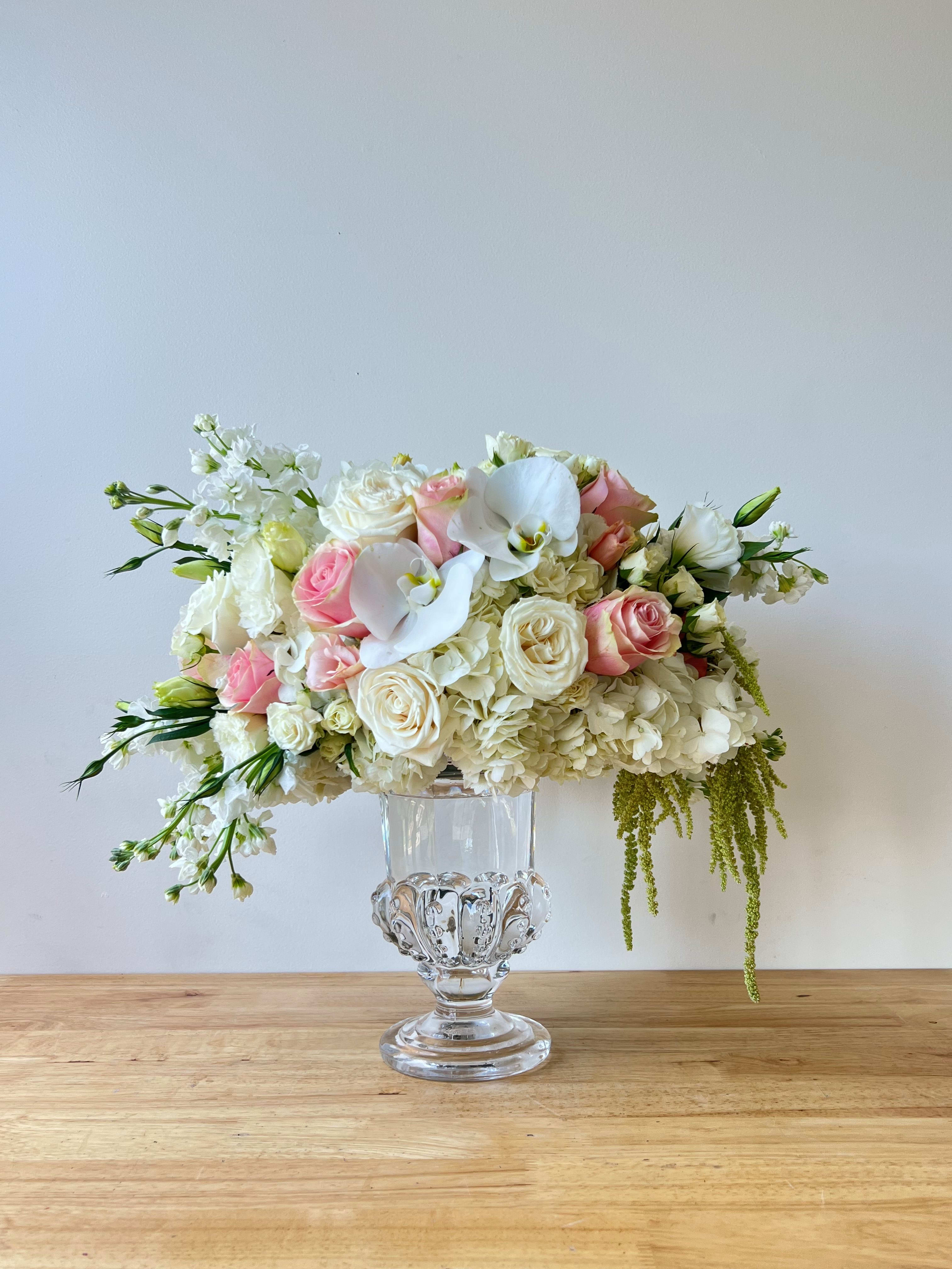 Crème de la Crème Crème de la Crème - Gorgeous round arrangement for any occasion; birthday gift, anniversary, weddings or events. This elegant arrangement contains a beautiful variety of seasonal flowers like; roses, hydrangeas, lisianthus, orchids, stock, and more.