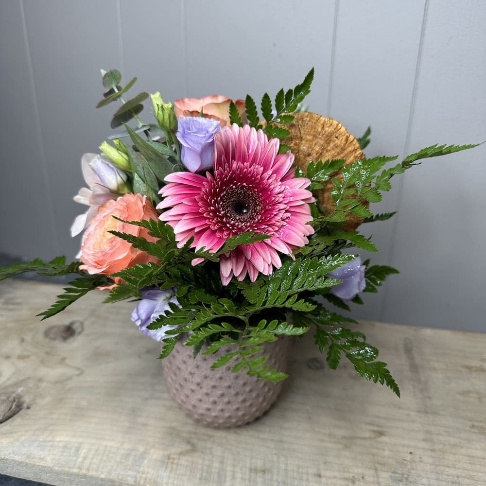 Boho Dream Arrangement - This combination of assorted florals in a boho-inspired arrangement is sure to create a lovely arrangement for your home. The reusable ceramic pot adds practicality and sustainability to the gift, making it even more appealing.