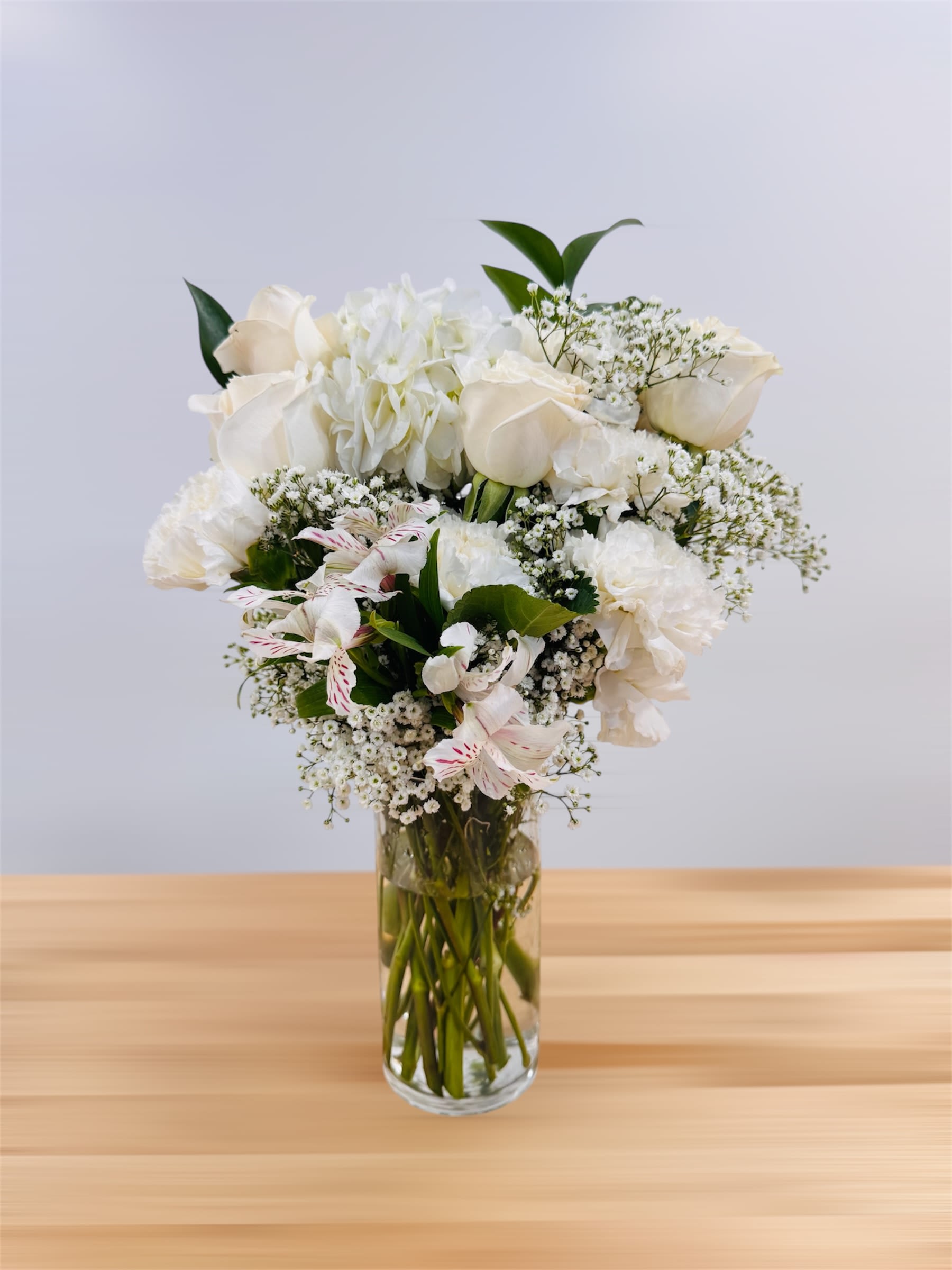 Armonico Armonico - This beautiful arrangement is perfect for sympathy or get well present. It has white roses, baby breath, ruscus fillers, carnation.