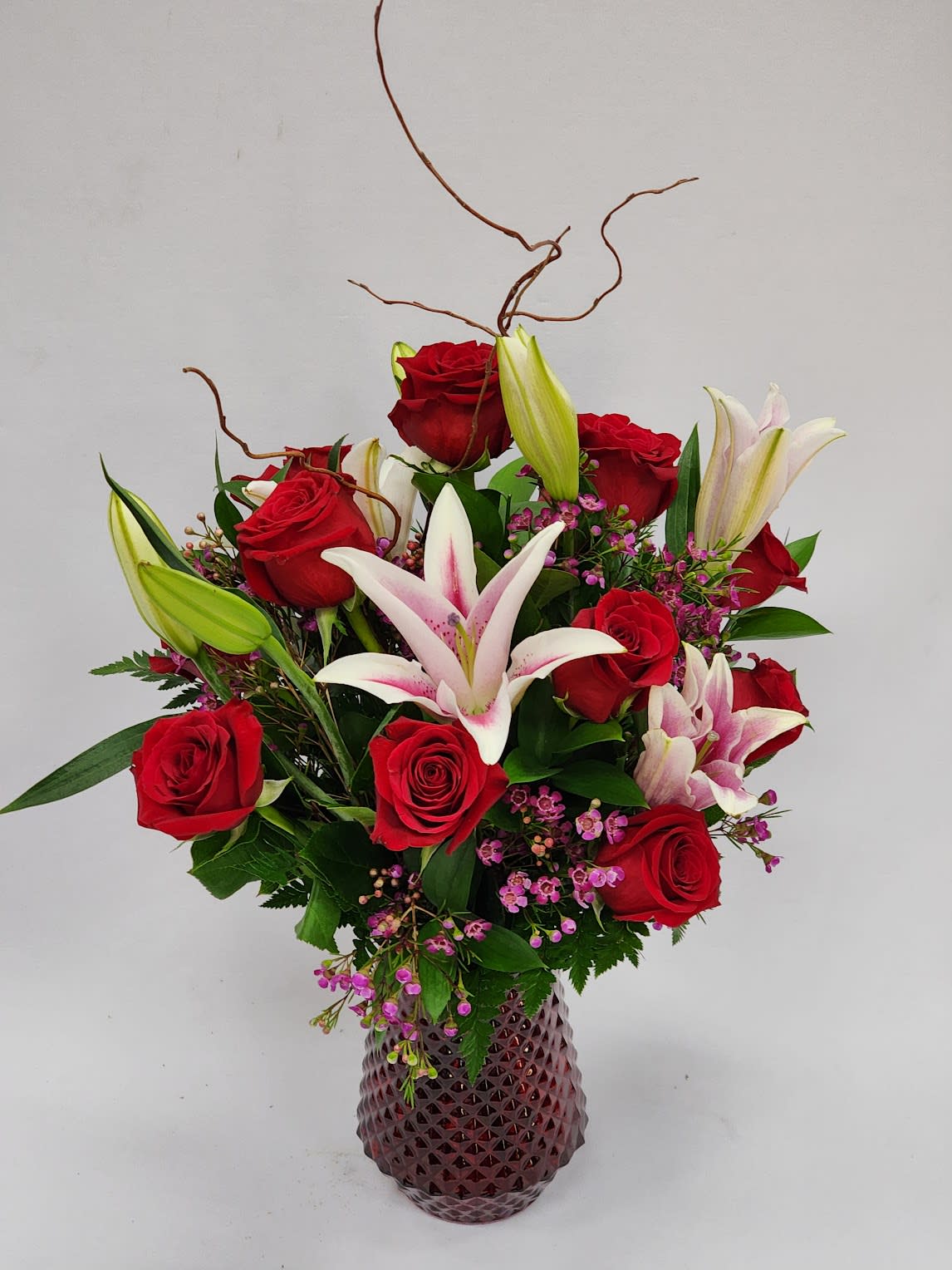 All For Love All For Love - Select this romantic and beautiful arrangement or red roses and stargazer lillies created in a red vase.