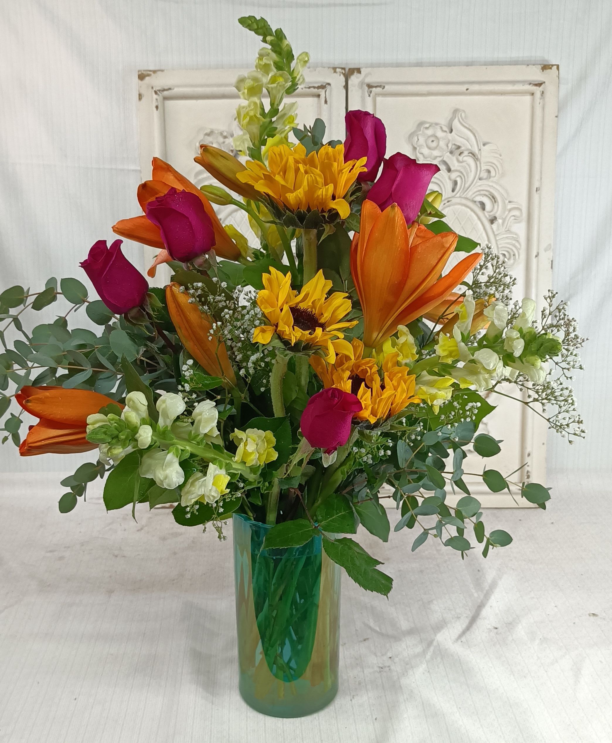 Summer Sunsets Bouquet Summer Sunsets Bouquet - Warm and bright colors in a pretty Turquoise vase.