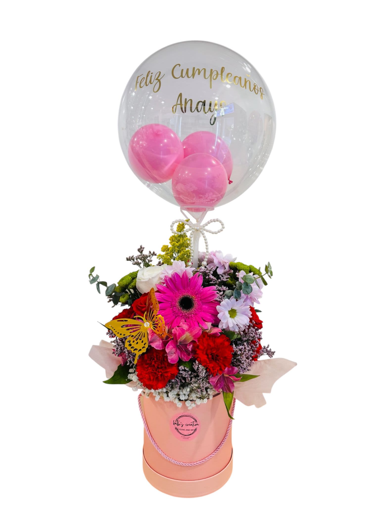 Enchanted Forest Enchanted Forest - It's a delightful floral arrangement in a pink box, white roses, filled with Gerber's daisies, carnations, and baby's breath, decorated with a golden butterfly and a clear balloon with a message.