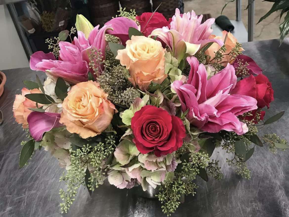 Designer's Choice Arrangement - A &quot;Designer’s Choice&quot; arrangement is a floral design that allows the florist or designer to use their creativity and expertise to select and arrange flowers based on their aesthetic judgment, seasonality, and the recipient’s needs. The customer typically provides a general idea of color scheme or style preferences, but the designer has the freedom to choose the flowers, textures, and overall look of the arrangement.