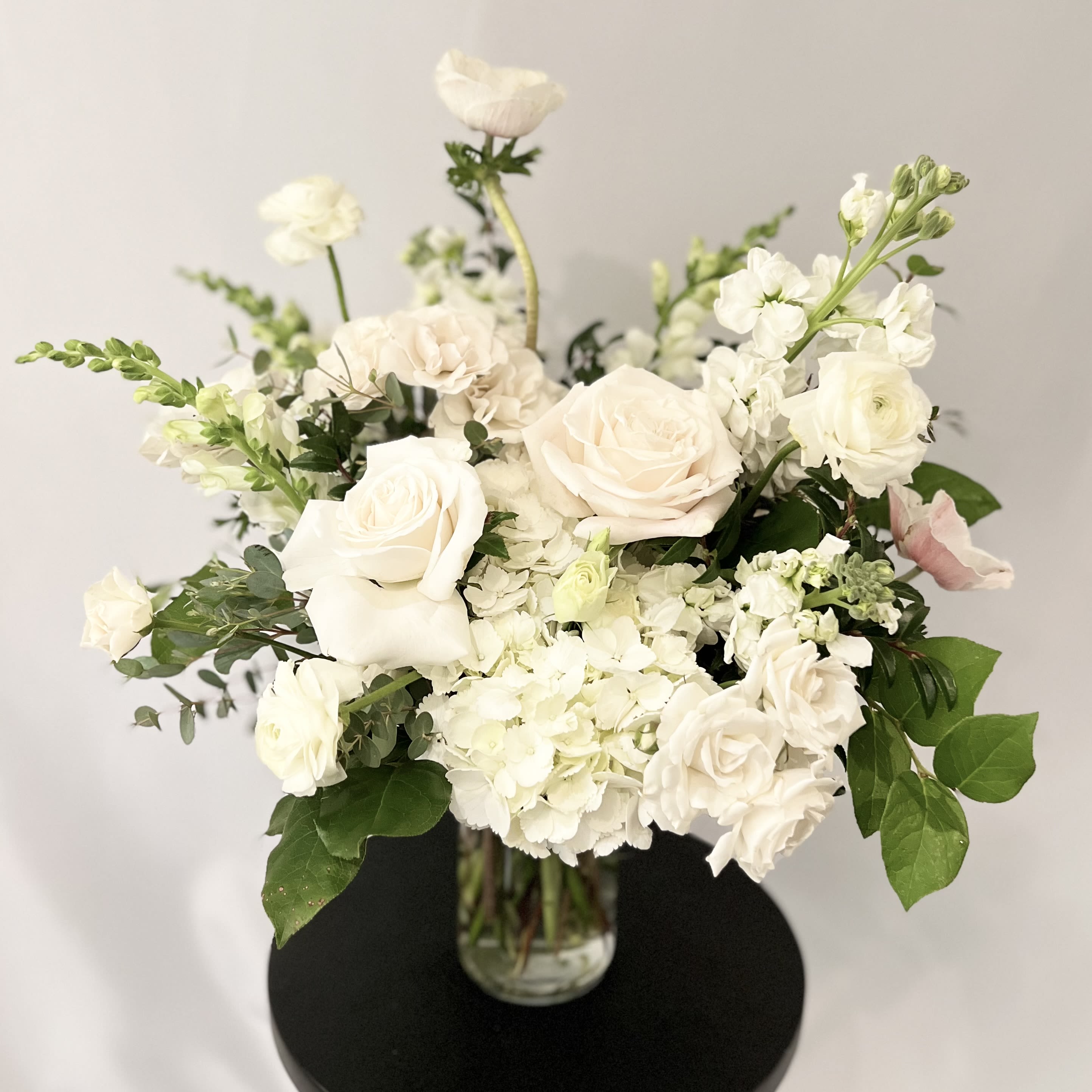 Pure White - English Garden - Luxury Collection - An exquisite English Garden styled arrangement of our white blooms from our weekly Studio Theme.  Specific flower varieties and colors pictured are not guaranteed. Each arrangement is delivered with a handwritten card.