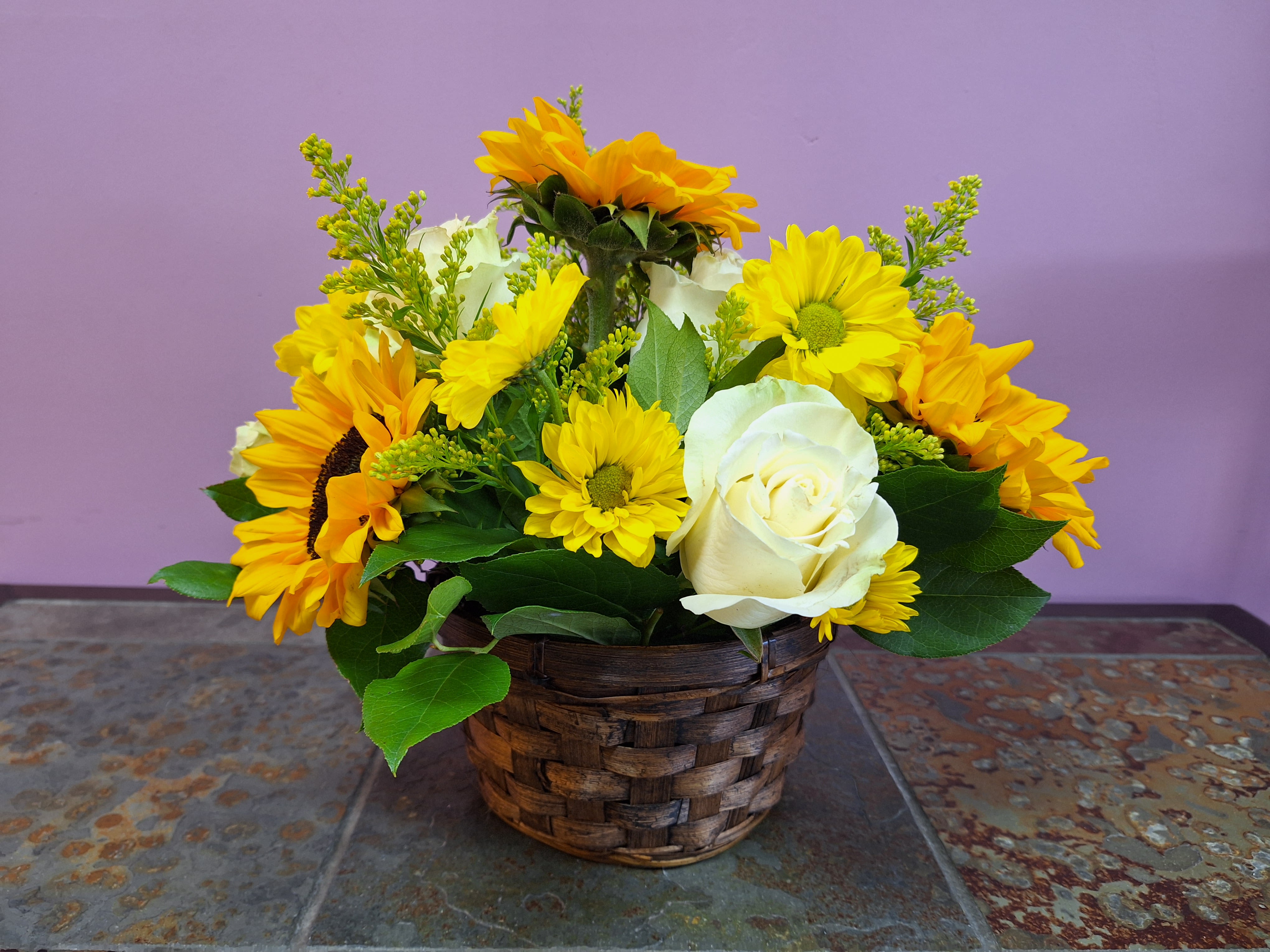 Golden Embrace - This basket arrangement includes; White rose, sunflowers, solidago and more. 