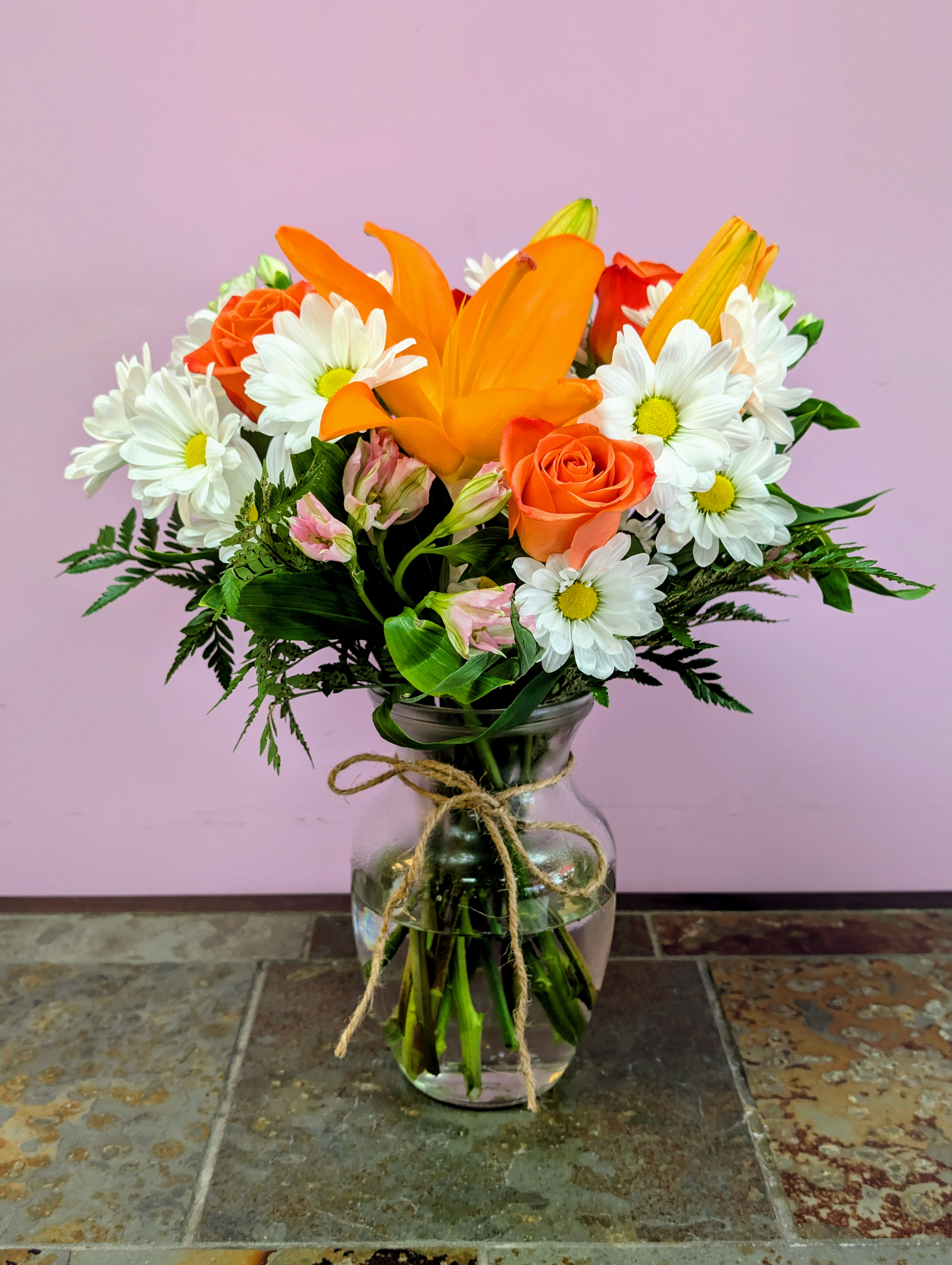 Sunset Orange - Bring peace through this Sunset Orange arrangement that includes: Orange roses, white daisies, orange lily and other. 