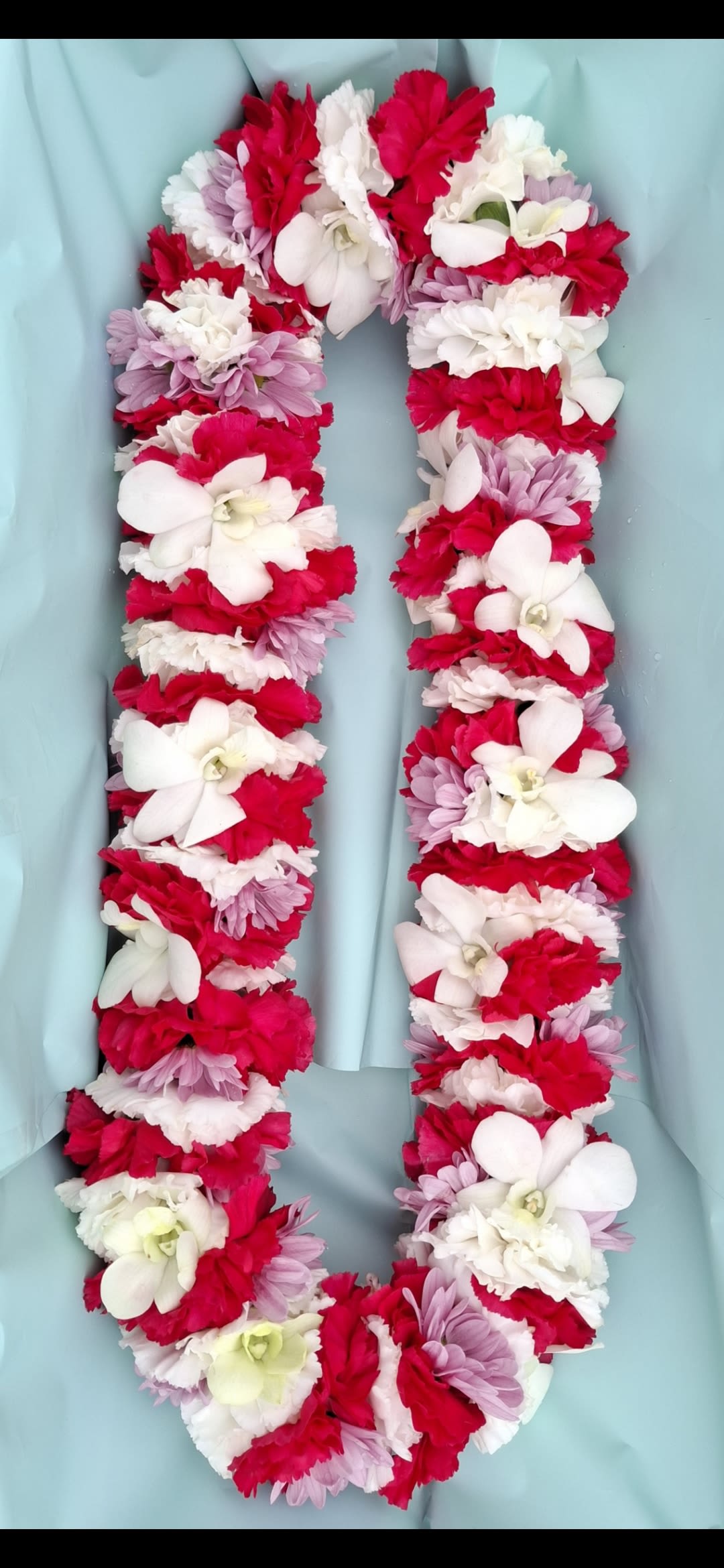 Milestone Celebration! - Cheerful &amp; Lush Lei delicately designed with fresh flowers that can definitely be requested in most any color. Please note, when placing this special floral piece please call beforehand to ensure accuracy.