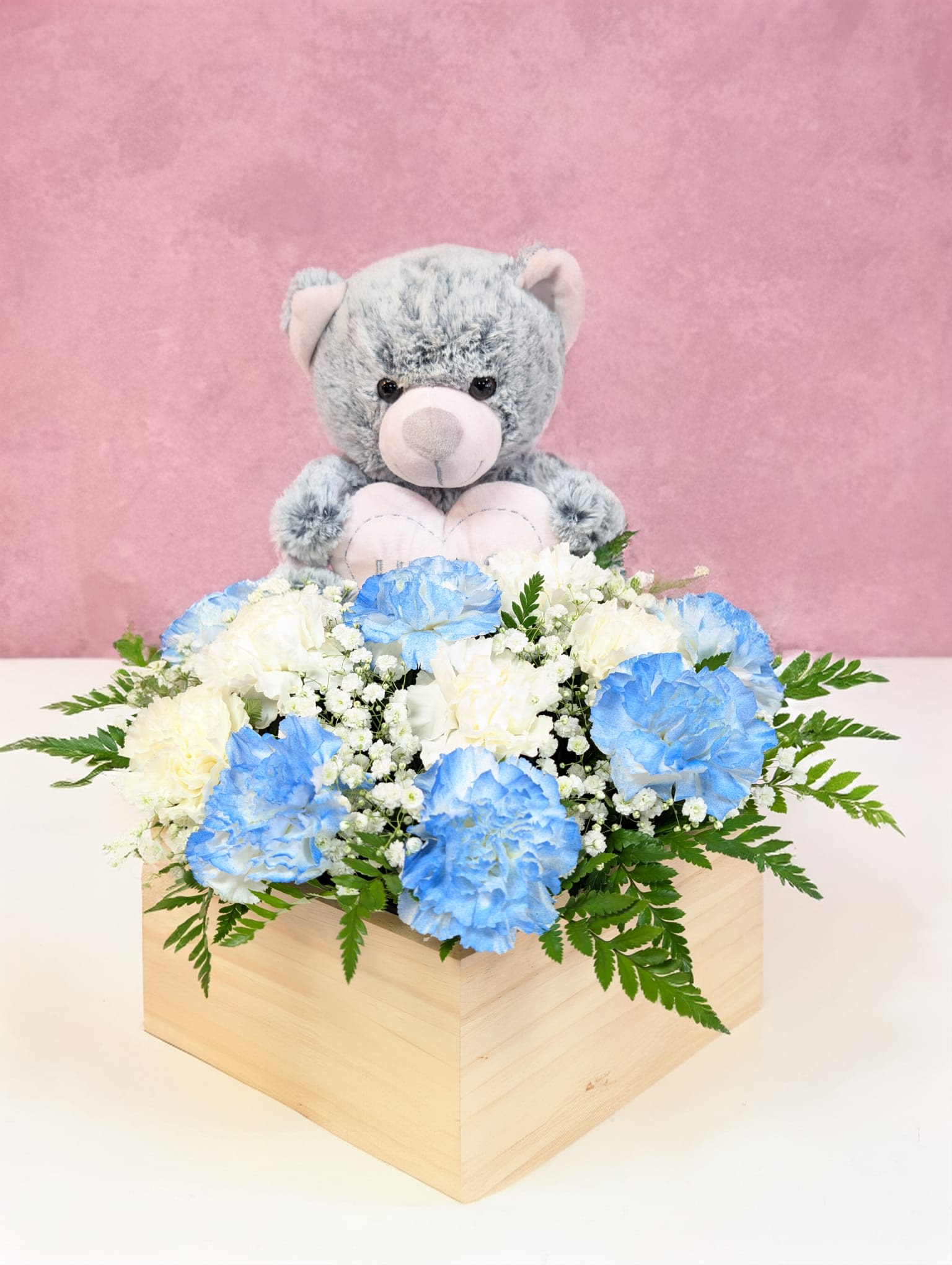 Bundle of Joy - Soft, serene and full of heart. This charming arrangement features blue and white carnations, with baby breath.