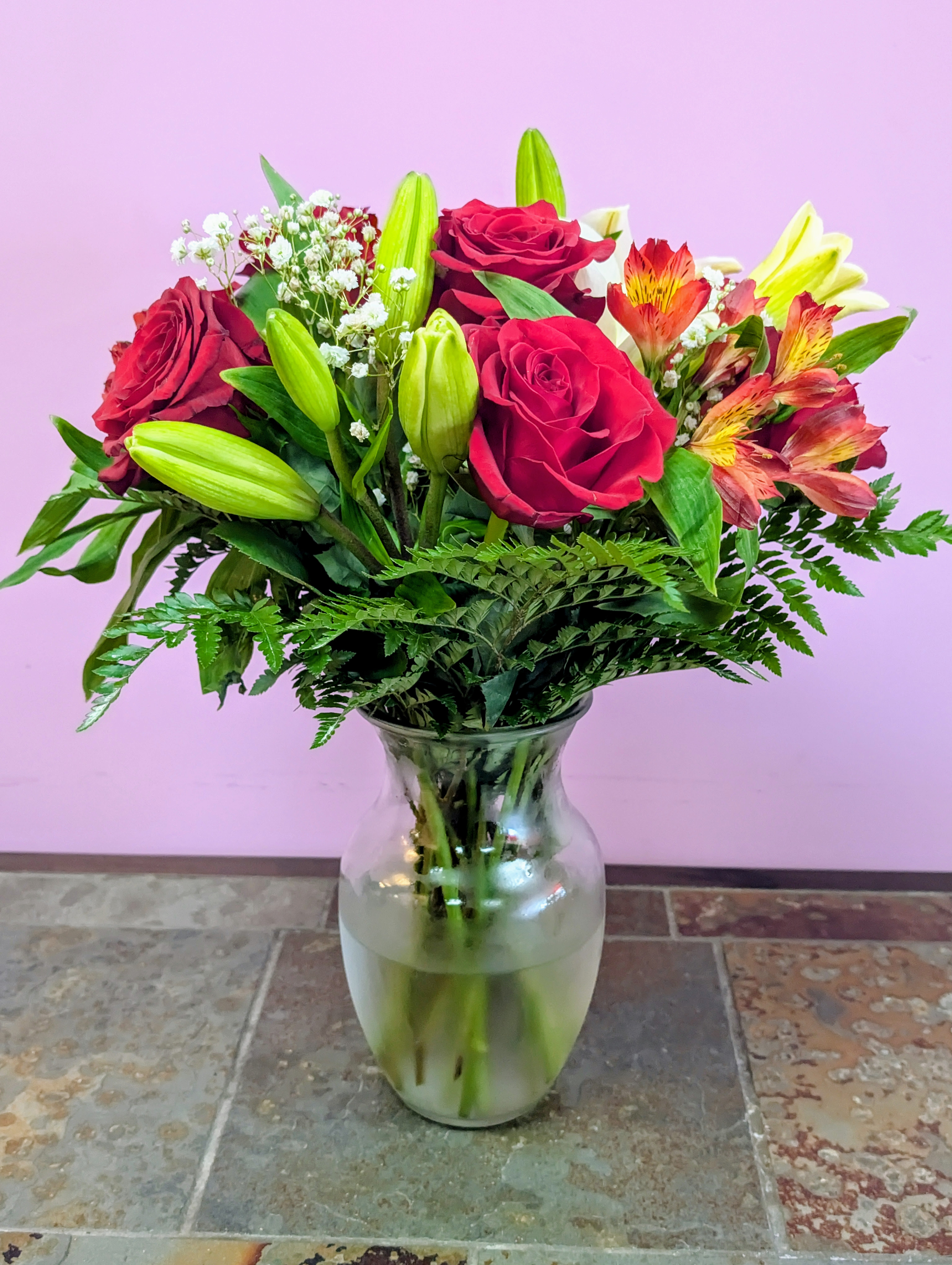 Heart Warming - This stunning floral arrangement features red roses, lilies, alstroemeria and more