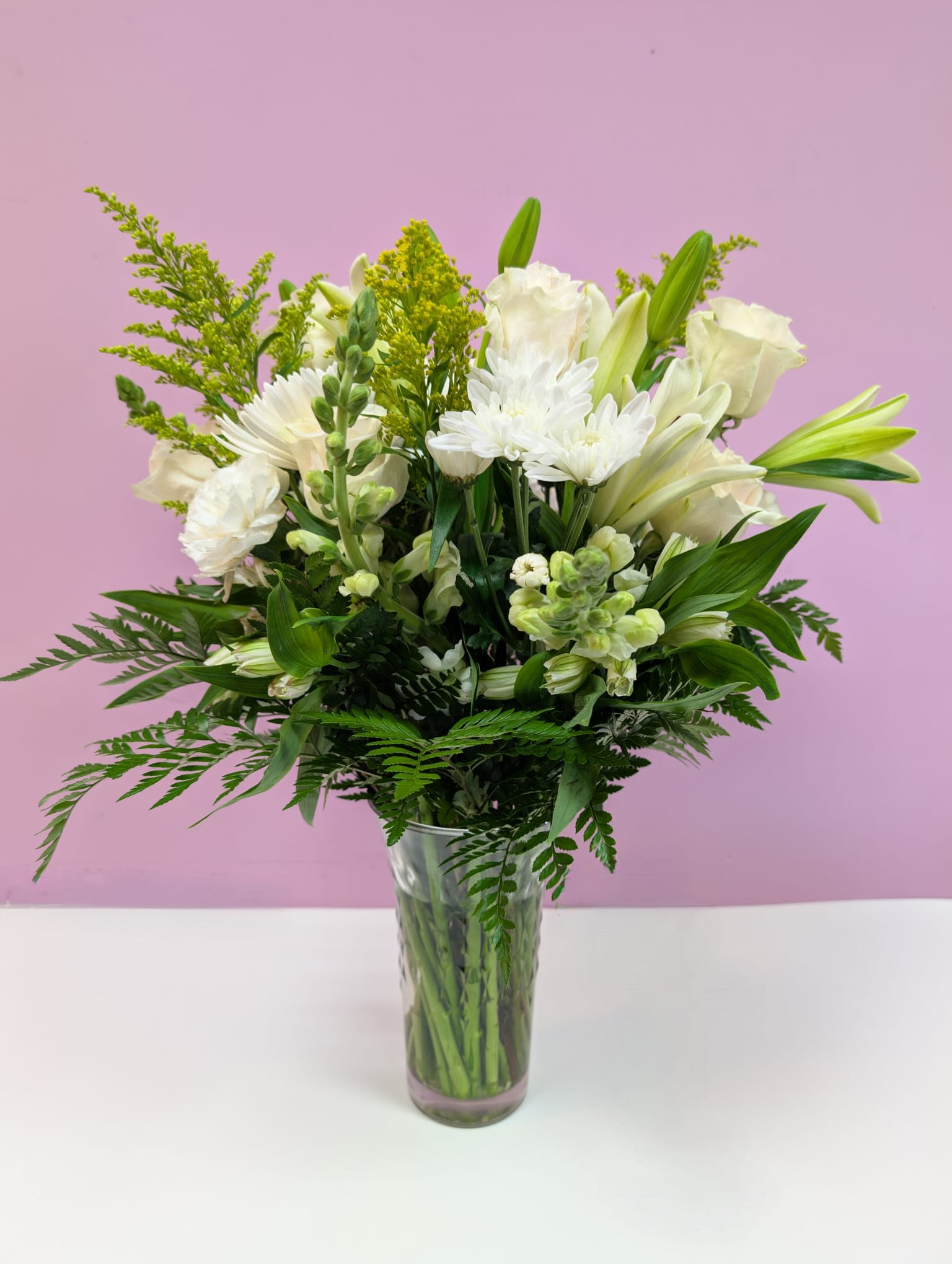 Crescent Moon - This arrangement feature white roses, lilies, mums and more.