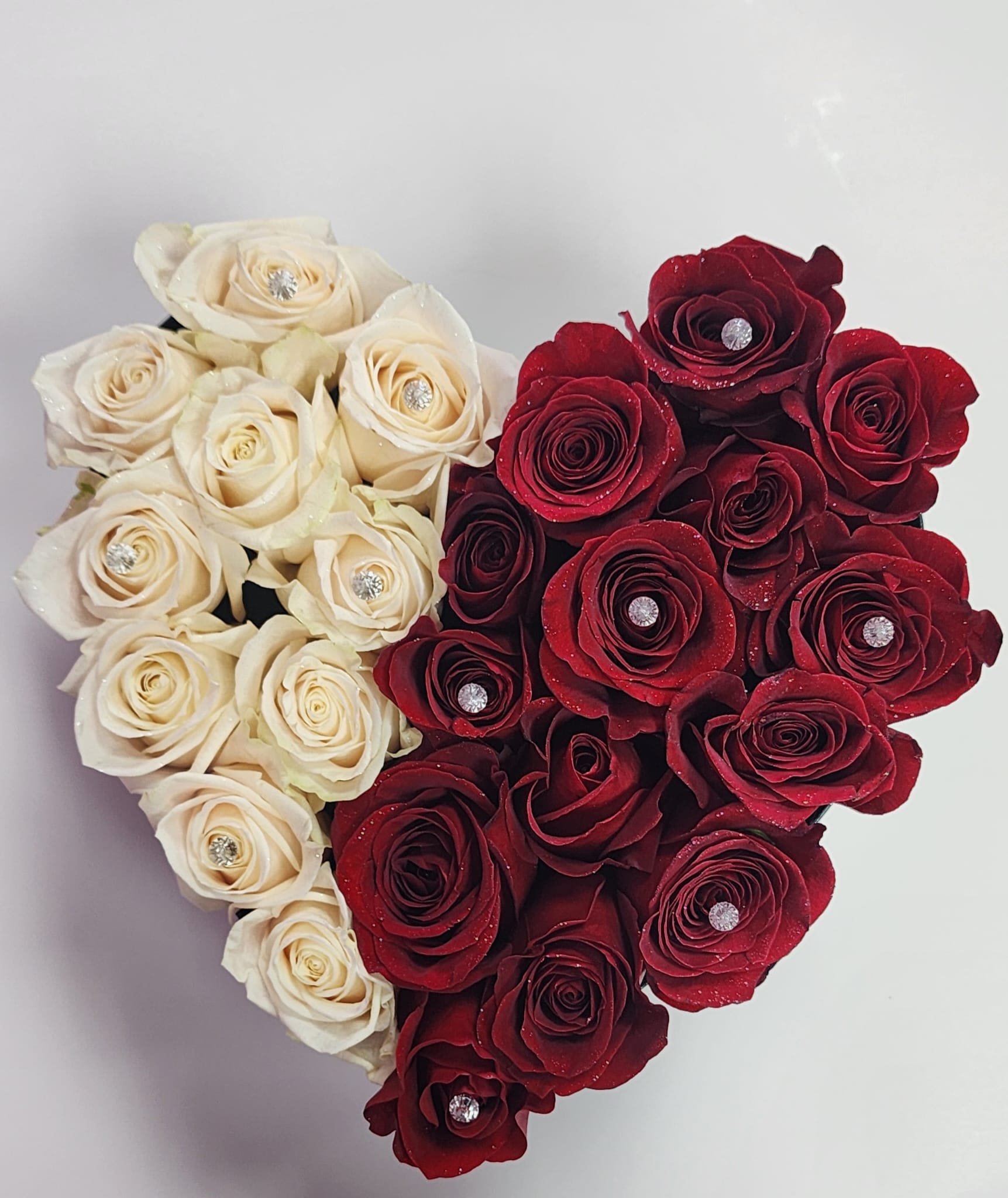 I Love You - What better way to declare one's love through a heart arrangement. Arrangement features red and white roses, with golden glitter and pins gently placed in roses. 