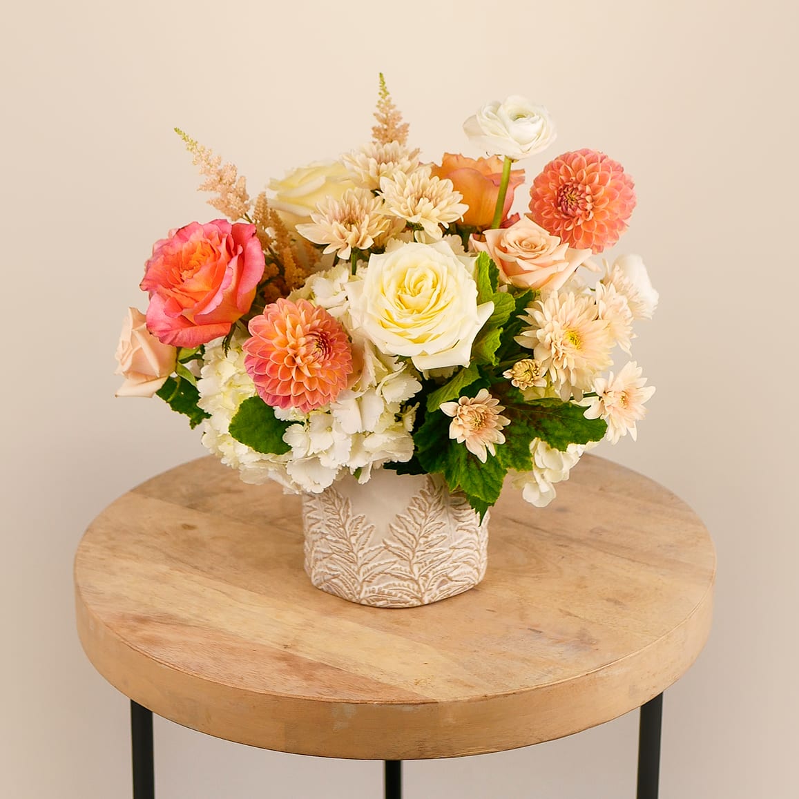 Soft Serenade - Delicate, romantic, and full of charm—our Soft Serenade arrangement is a graceful blend of cream, peach, and blush blooms including dahlias, garden roses, ranunculus, mums and hydrangea. Artfully designed in ceramic container, this arrangement brings a touch of elegance to any space. Perfect for birthdays, thank yous, or simply brightening someone’s day with beauty and warmth.