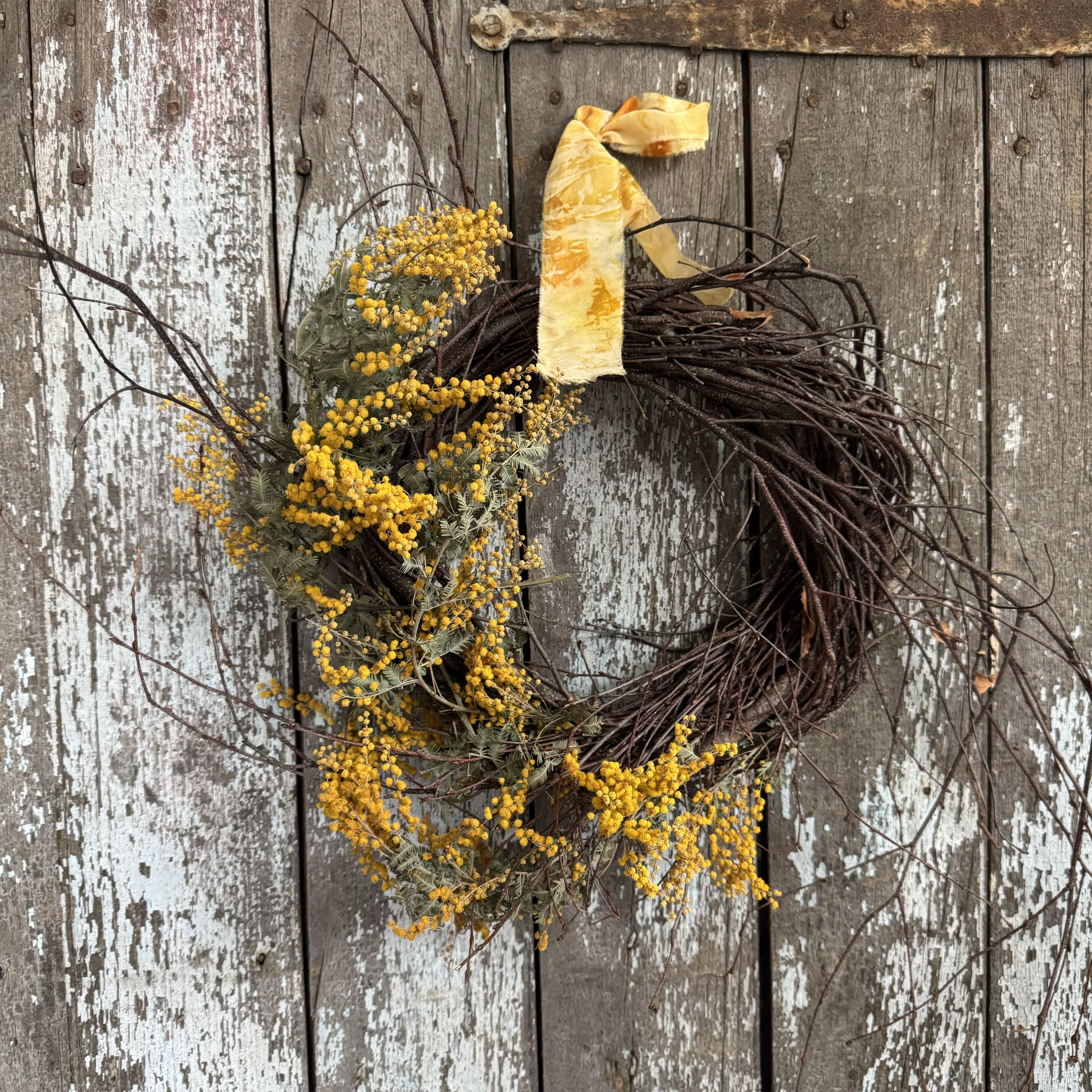 Wild Summer Wreath - Add a touch of summer beauty to your home with our seasonal wreaths. Handcrafted with an assortment of lush and bright stems, these wreaths bring the blooming charm of spring right to your doorstep. I am currently offering 2 options for wreaths: a bright yellow mimosa wreath or a bright white limonium wreath. Both are tied off with a hand made pure silk ribbon. Please ensure to make your preferred wreath selection before checking out.  The dimensions of the wreaths are approximately 12&quot; across, not including the wild branches that give them their free-spirited look.  Whether you're gifting it or adorning your own home, this wreath is sure to bring a fresh, bright touch to your space!