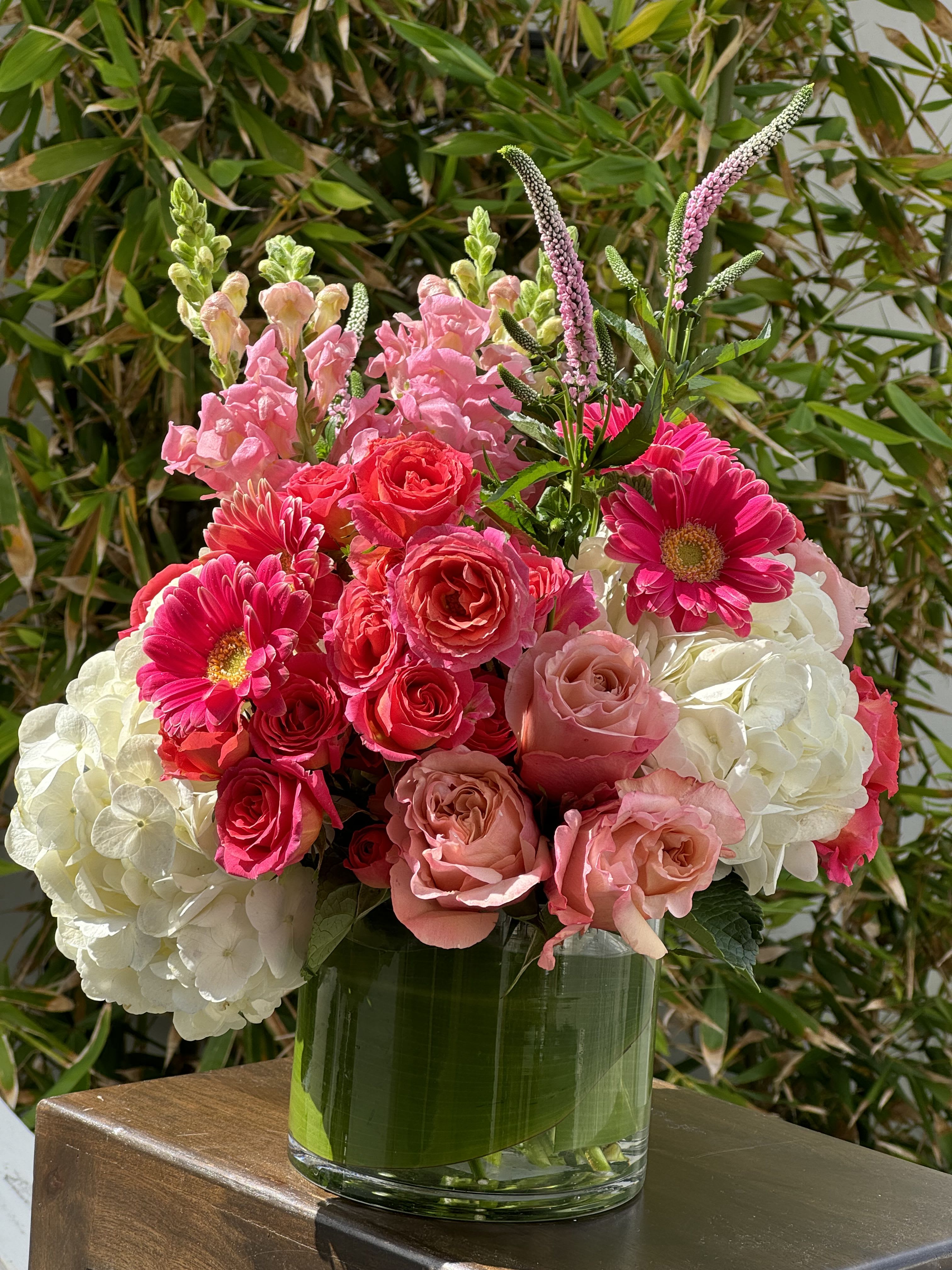 BLOOM BOOM - A beautiful arrangement of pinks , this one comes in a 6x5 heavy glass container and is full of beautiful pink and white flowers…gerber daisies, roses, hydrangeas, beautiful greens!!!