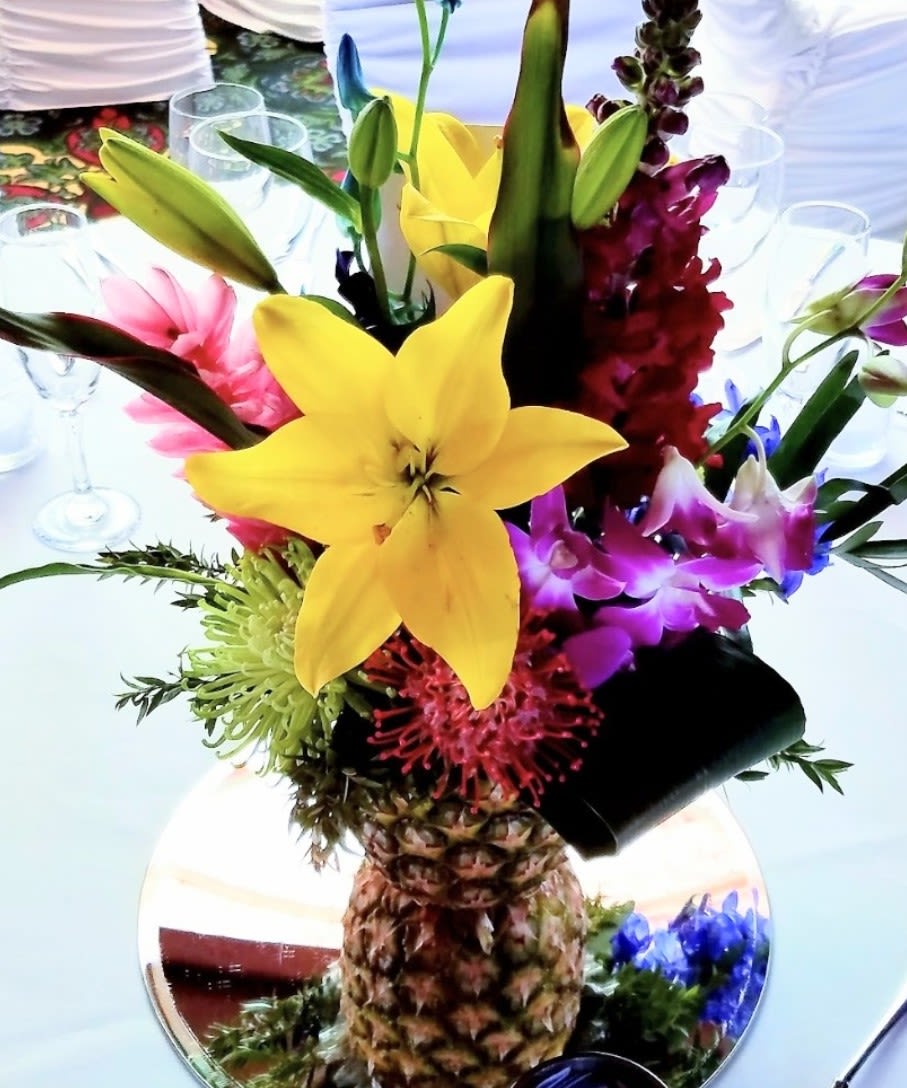 Tropical bliss  - Bring paradise to your next special event in natural pineapple filled with an array of exotic blooms. 