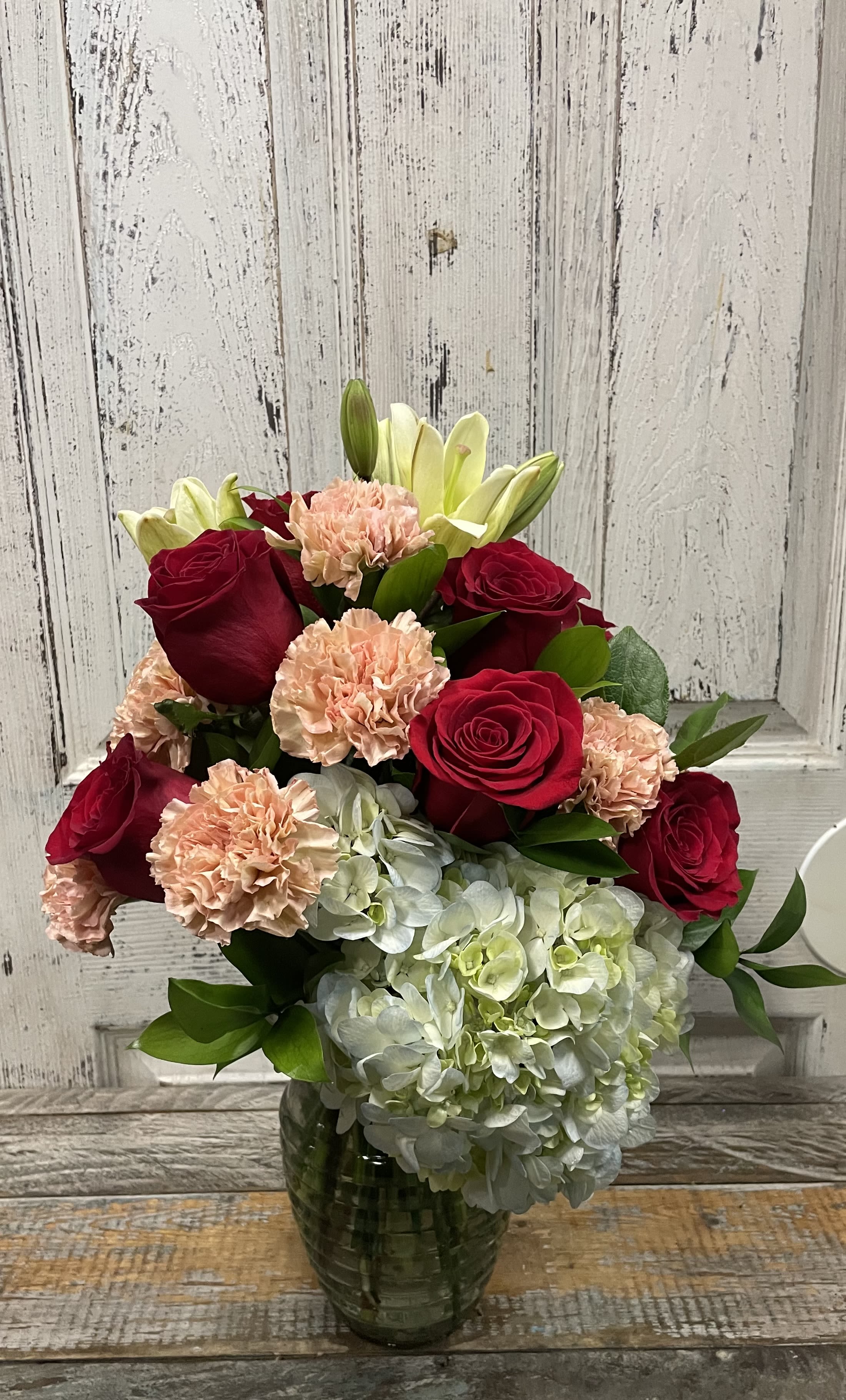 Sweet Talk - A Beautiful mixture of red roses, blush and pink carnations! popping out are a few Asiatic lilies and fluffy hydrangeas! ^_^  A soft and sweet way to give love and joy to your favorite person. 