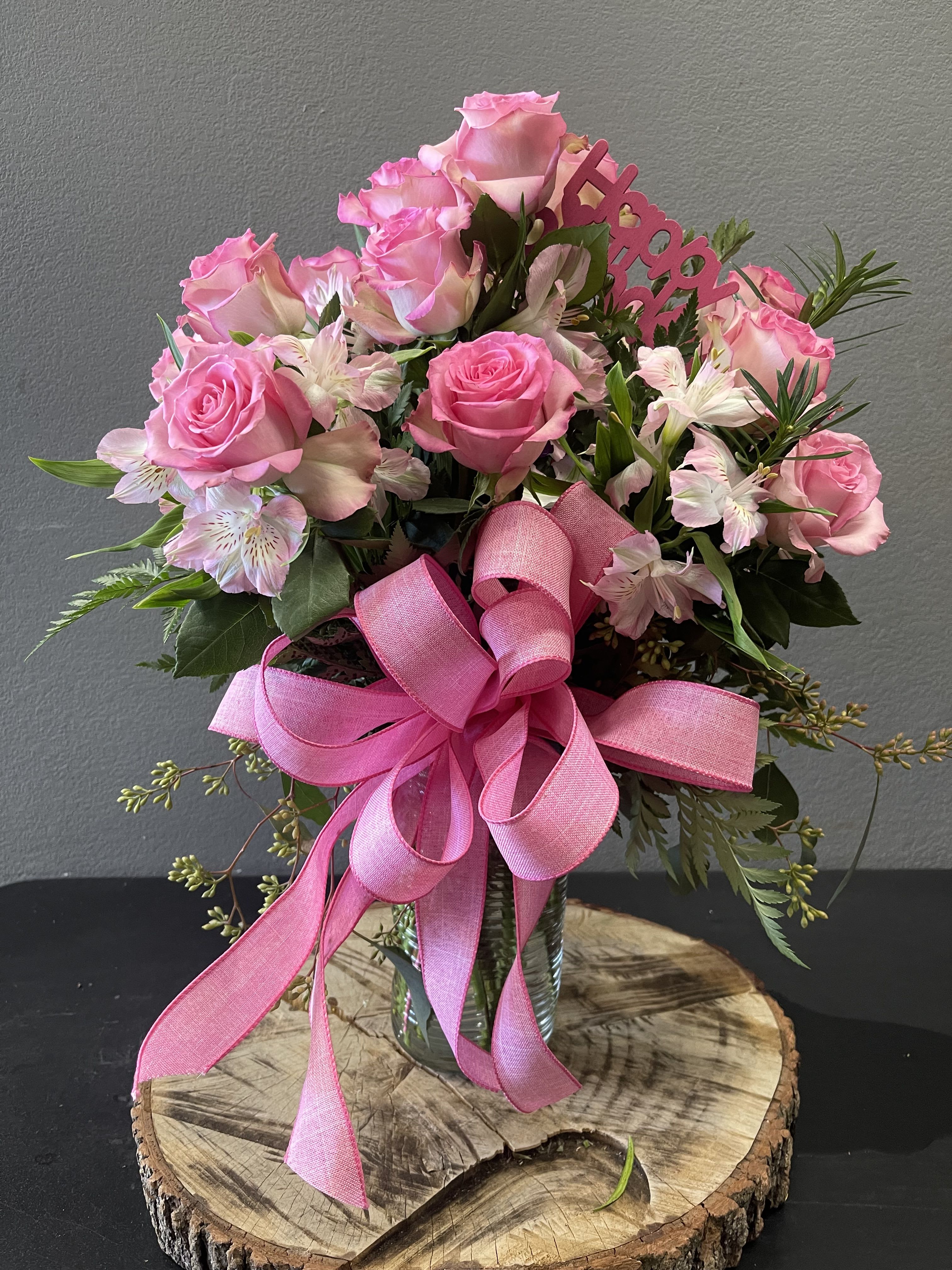 Pink Birthday Surprise - A beautiful arrangement with pink roses and a special Happy Birthday pick.