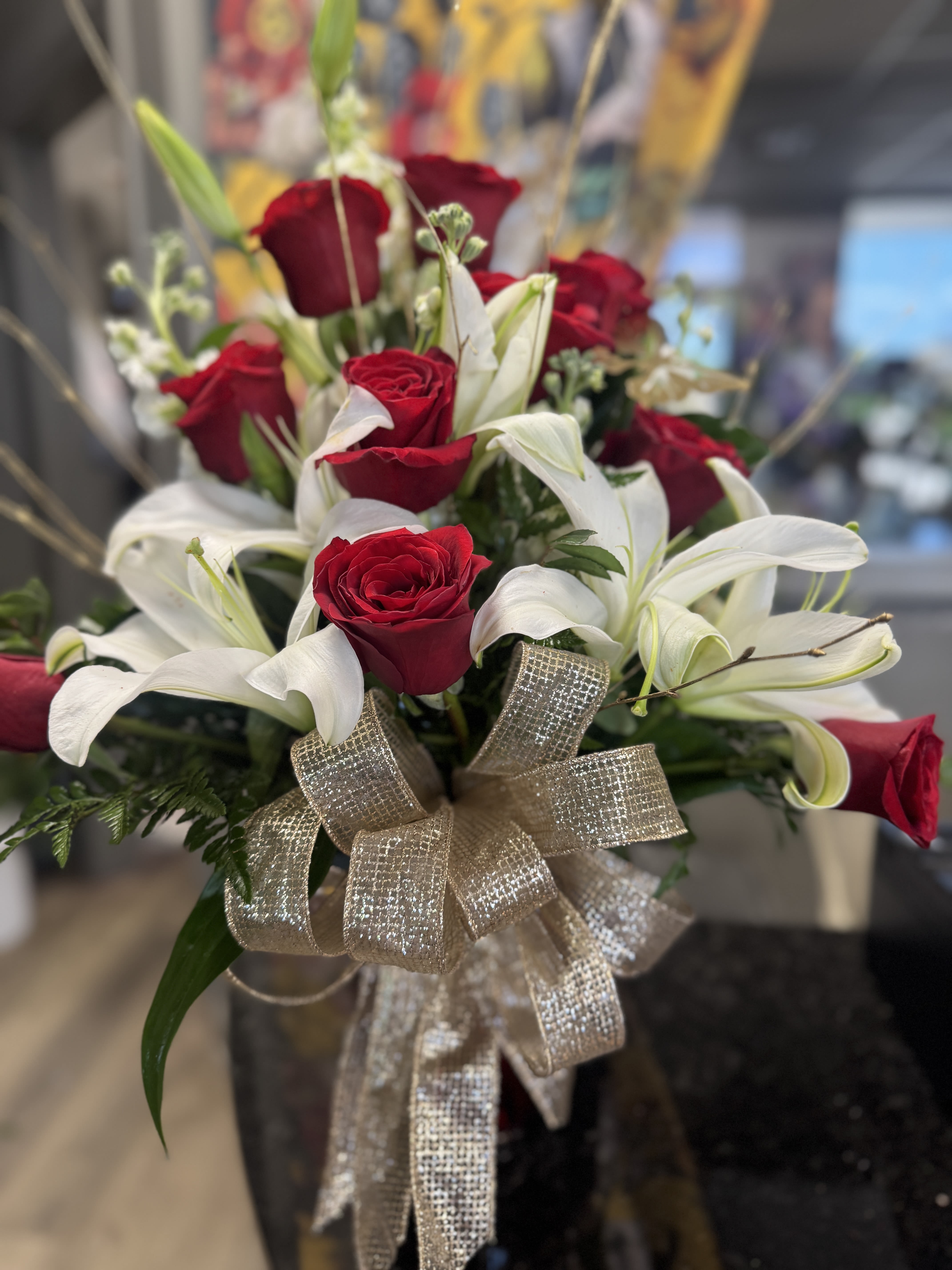 Golden Years - A beautiful one sided red rose arrangement with white cala lilies, greenery and gold accents. 