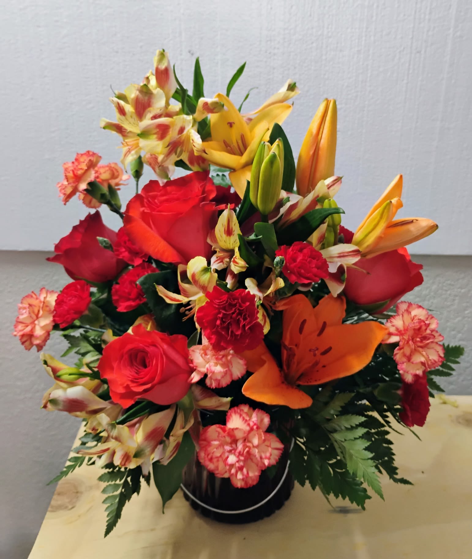 Summertime Sunset - This arrangement is a mixture of beautiful lilies, roses, carnations, and alstroemeria. Perfect for most occasions!
