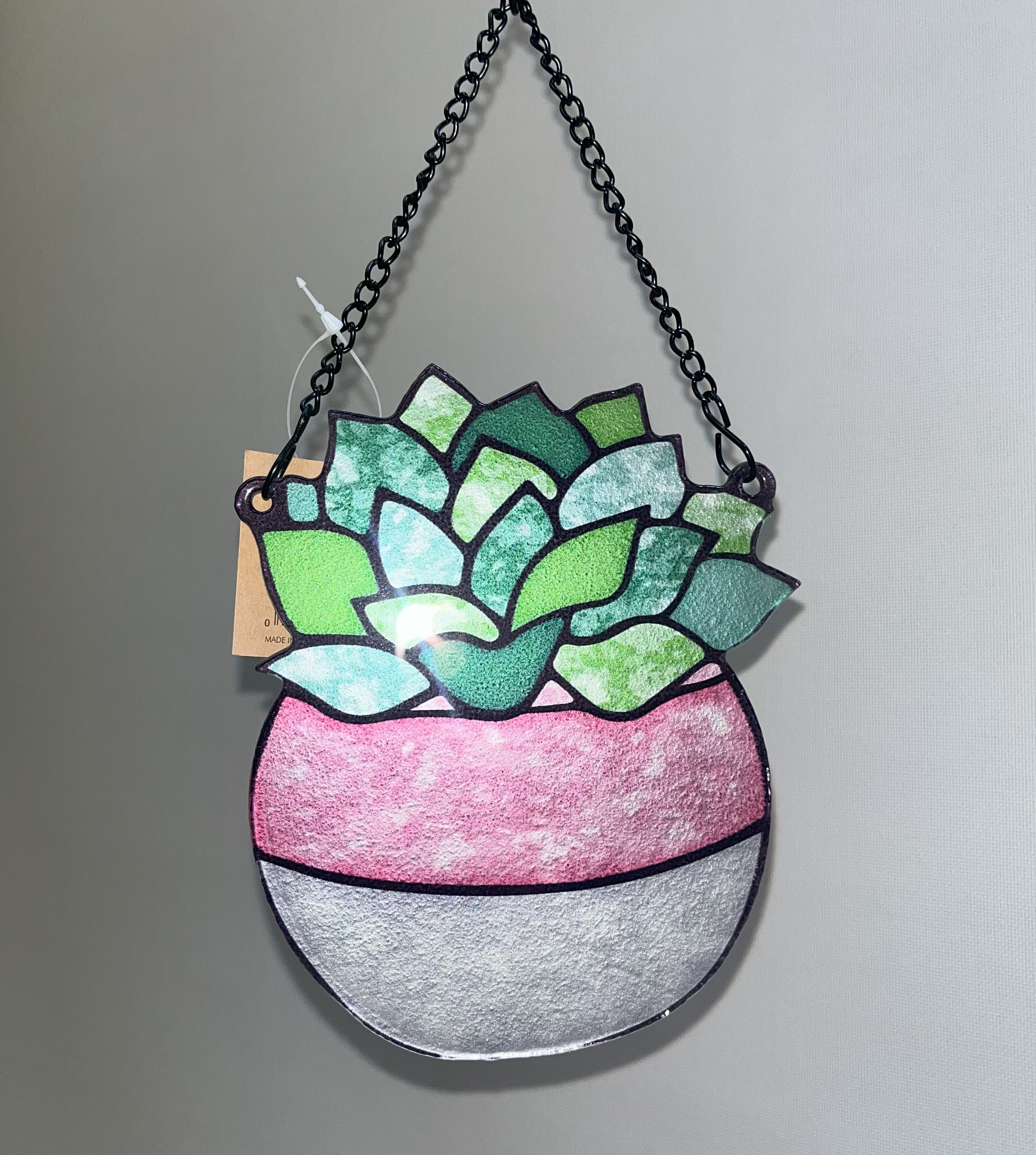 Stained Glass Succulent Hanger Stained Glass Succulent Hanger - This stained glass plant hanger is able to hang from a window with a suction cup (provided), and could easily be put in a garden with a stake. Appropriate for any occasion.