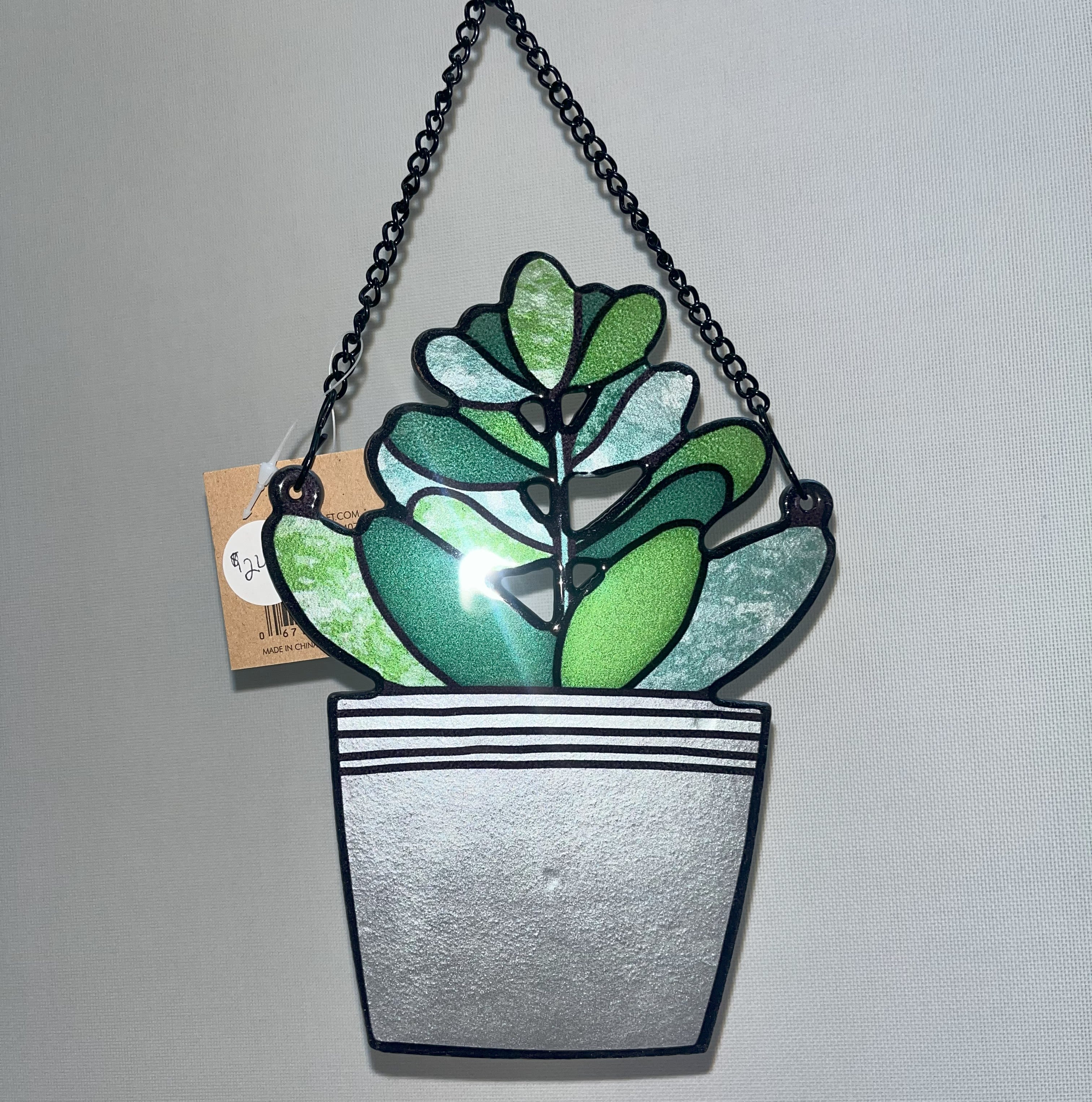 Stained Glass Green Plant Stained Glass Green Plant - This stained glass plant hanger is able to hang from a window with a suction cup (provided), and could easily be put in a garden with a stake. Appropriate for any occasion.