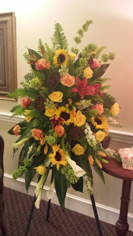 Garden of Gratitude Easel Spray by Simply Flowers - A gorgeous design full of color and texture. Calla lilies, roses, sunflowers, Asiatic lilies and more make up this beautiful tribute that bring warmth and comfort during a difficult time. 