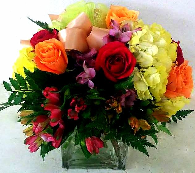 Bright mix in a glass cube vase. - Fresh floral.