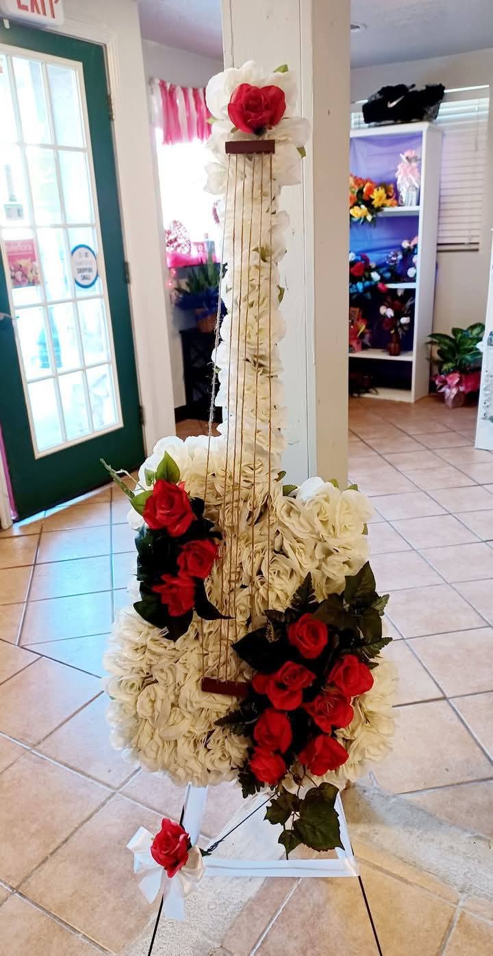 Guitar - Beautiful Silk Spray shaped as a guitar. We can make in any color. 40 inches tall. Funeral.